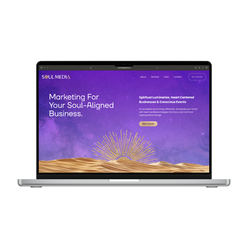 A laptop displaying a website homepage for Soul Media, with a purple starry sky background, golden sand dunes at the bottom, and a sunburst graphic. The page features text about marketing for soul-aligned businesses and a call-to-action button.