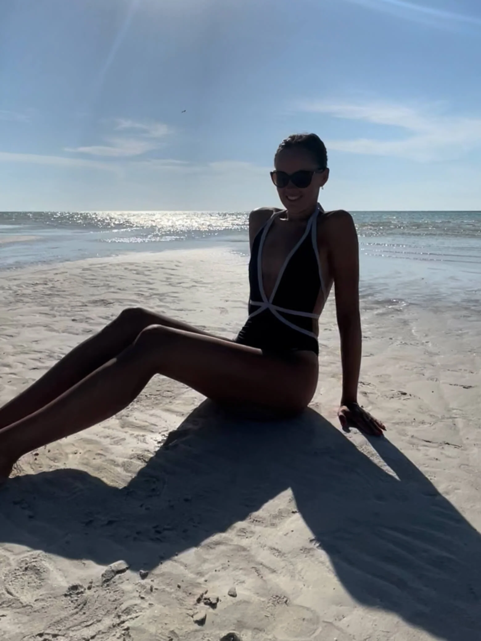 Sarah sat on a beach
