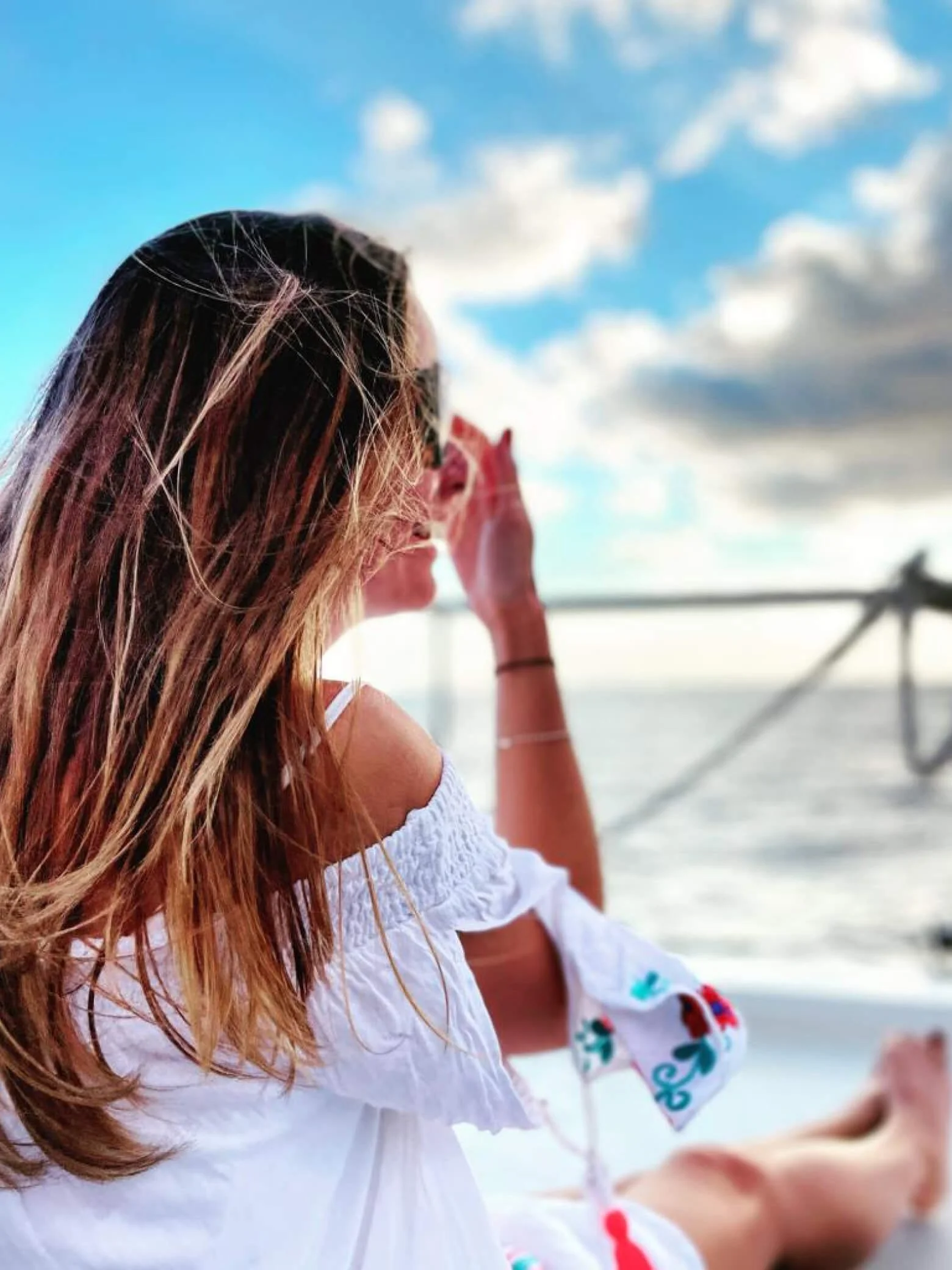 Sarah on a boat looking out over the ocean