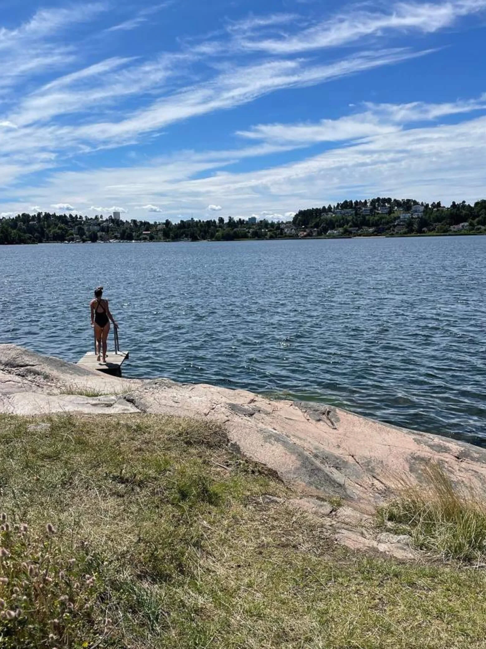 Sarah standing by a lake