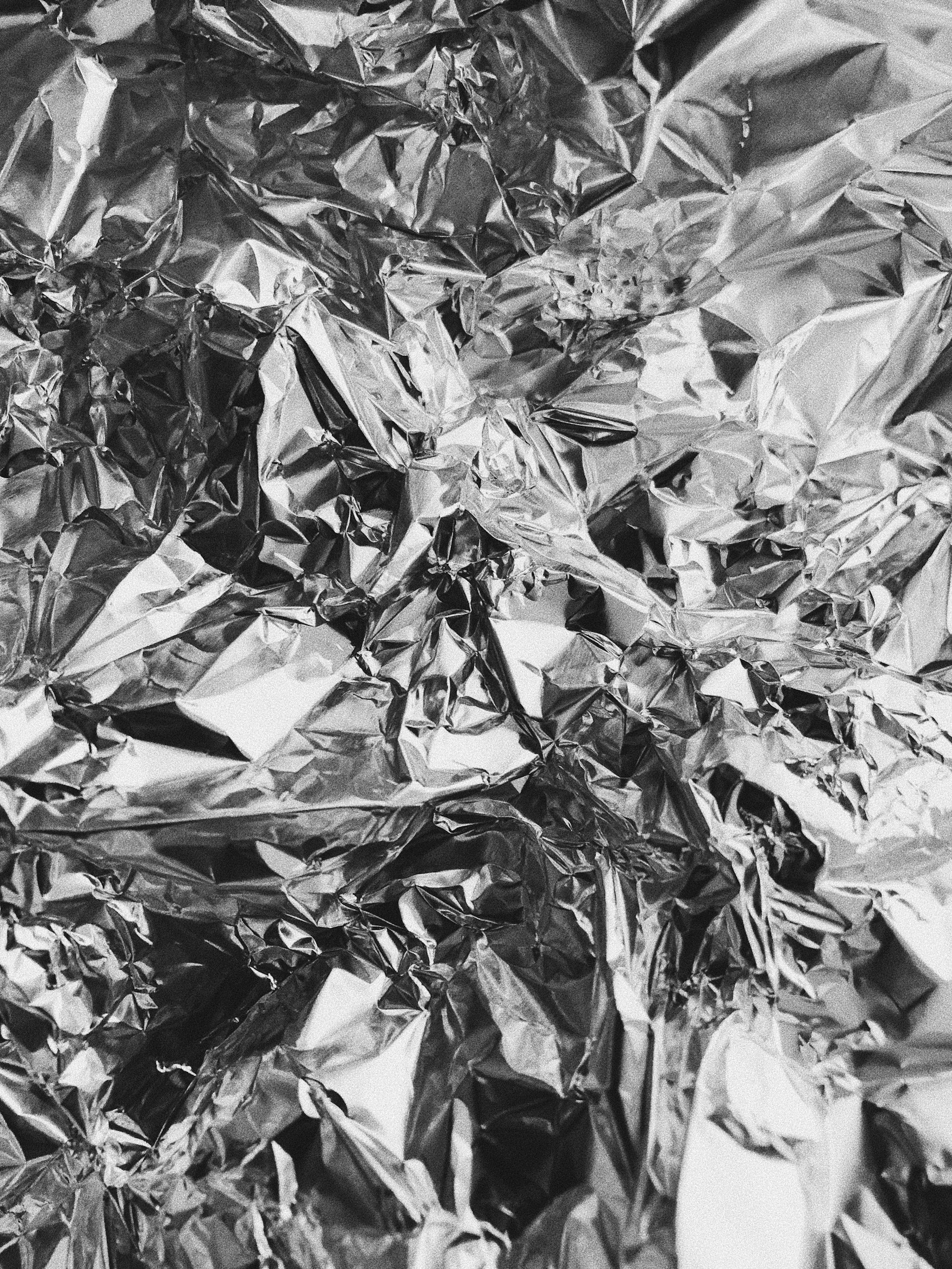 A close-up of crumpled aluminum foil covering the surface.