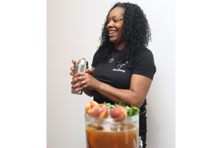 Melyssa Robinson of Mixing with Mel Mobile Bartending shaking a cocktail mixer