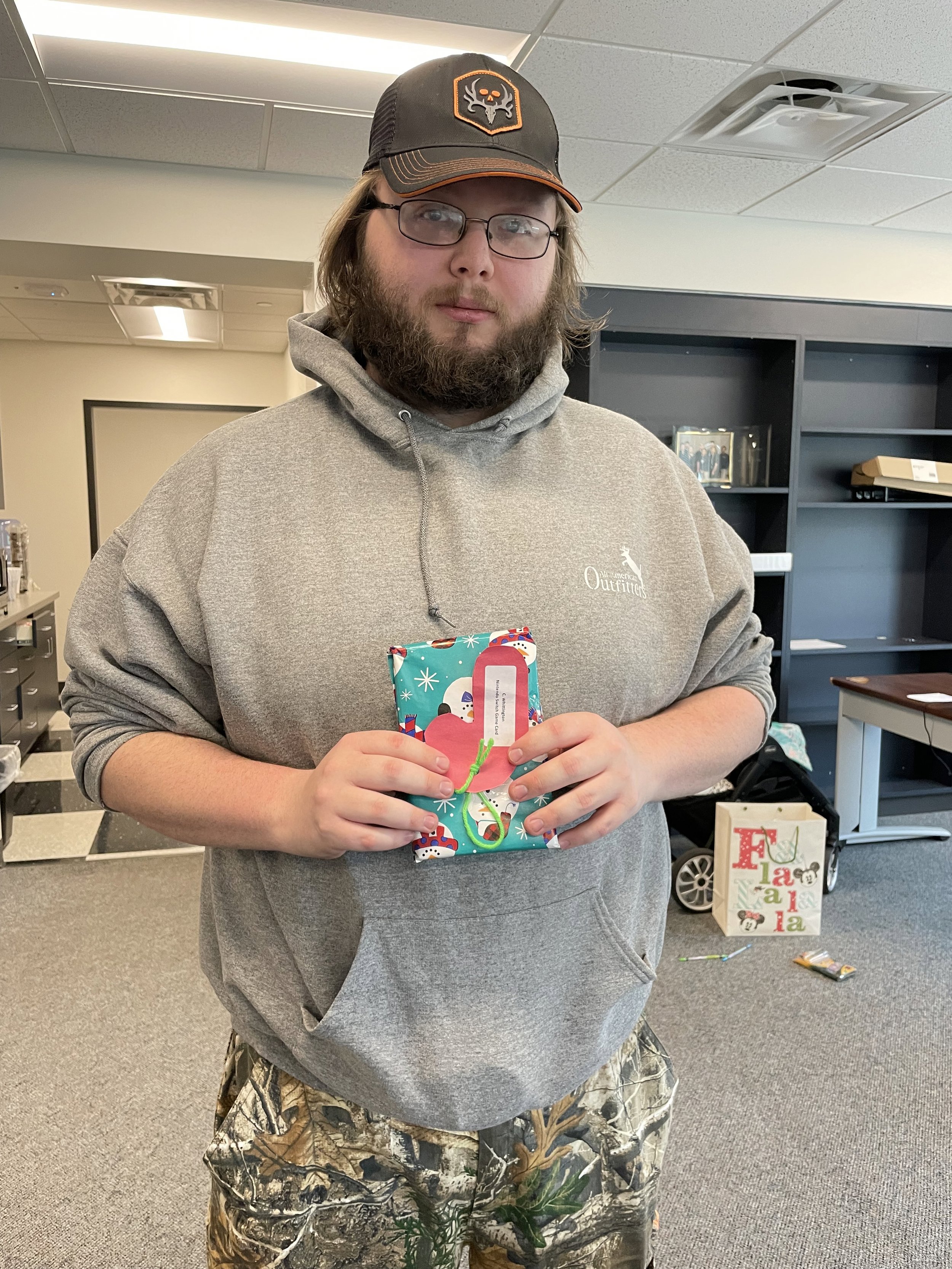 ProjectSEARCH graduate and Winchester Medical Center employee, Colton holds his gift from NW Works