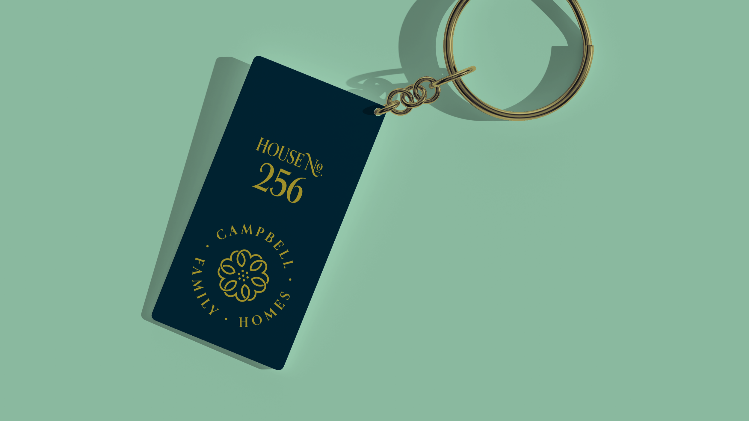 Keychain design with navy color and gold accents for the keyring and muted gold house number lettering on a mint-colored background.