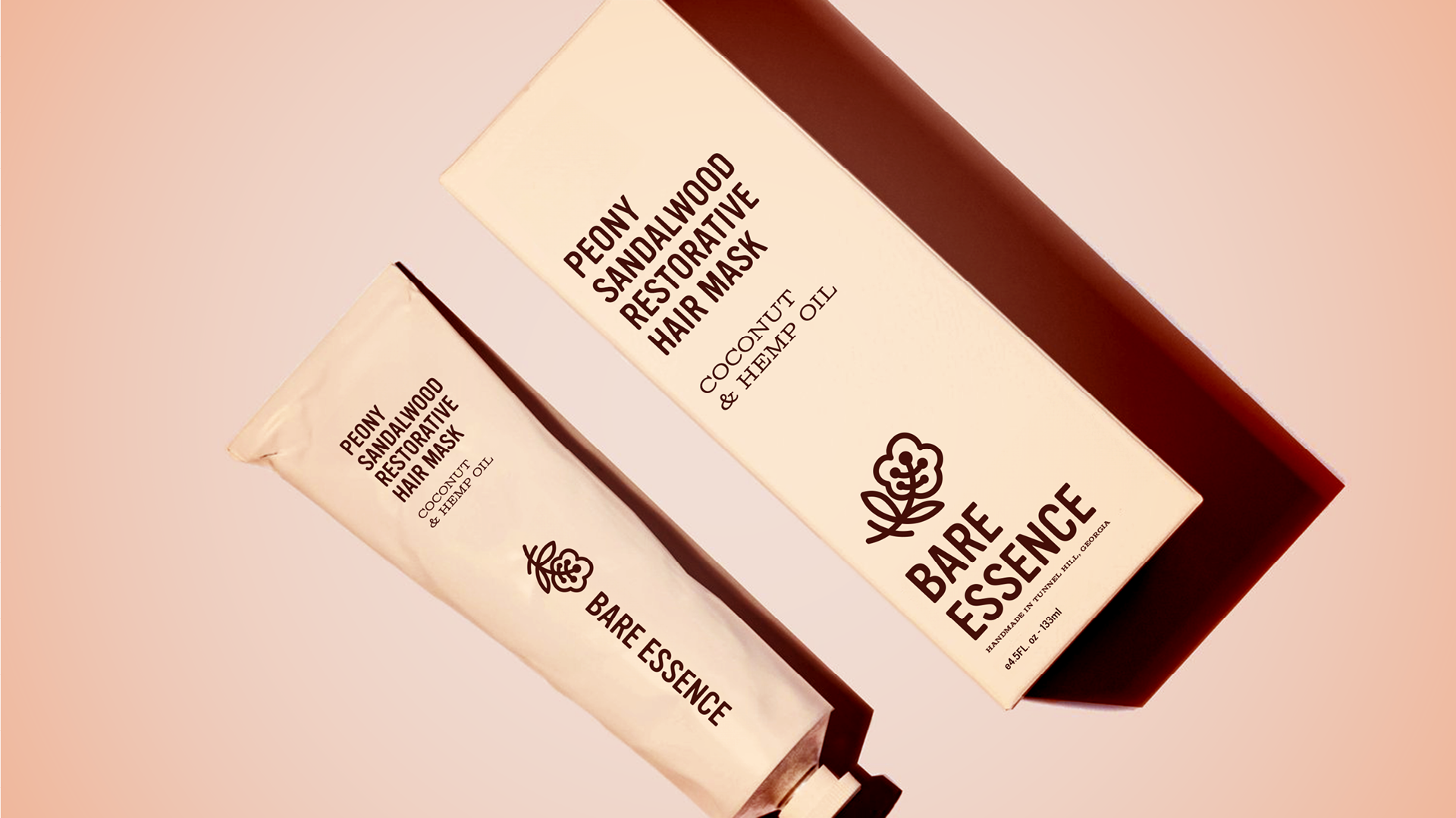 Product image of the hair mask product in a stark contrast photo with a cream-colored box and product tube, featuring the full label design and appropriate logo versions for each: primary and horizontal.