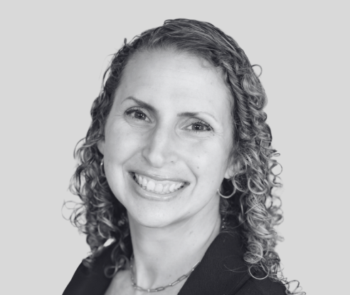 Black and white portrait of a woman with curly hair smiling at the camera. Tanya Kessling, Winner of Best Physiotherapy Clinic in Campbell River, Finalist for Best Physiotherapists in Campbell River