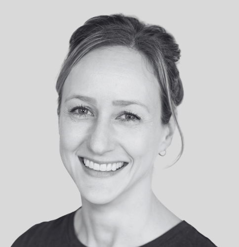 Black and white photo of a smiling woman with straight hair, facing the camera. Kinesiologist, exercise classes, exercise therapy, fitness