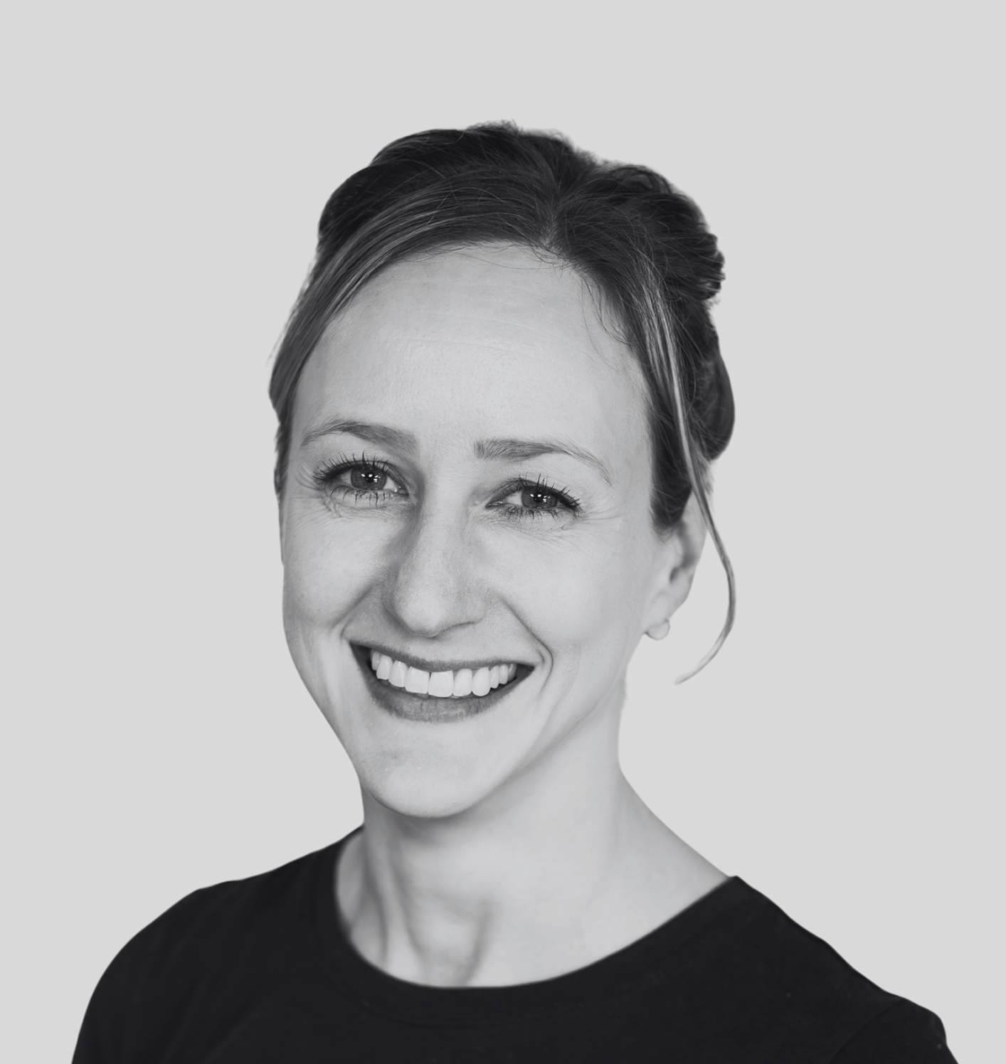 Black and white photo of a smiling woman with straight hair, facing the camera. Kinesiologist, exercise classes, exercise therapy, fitness