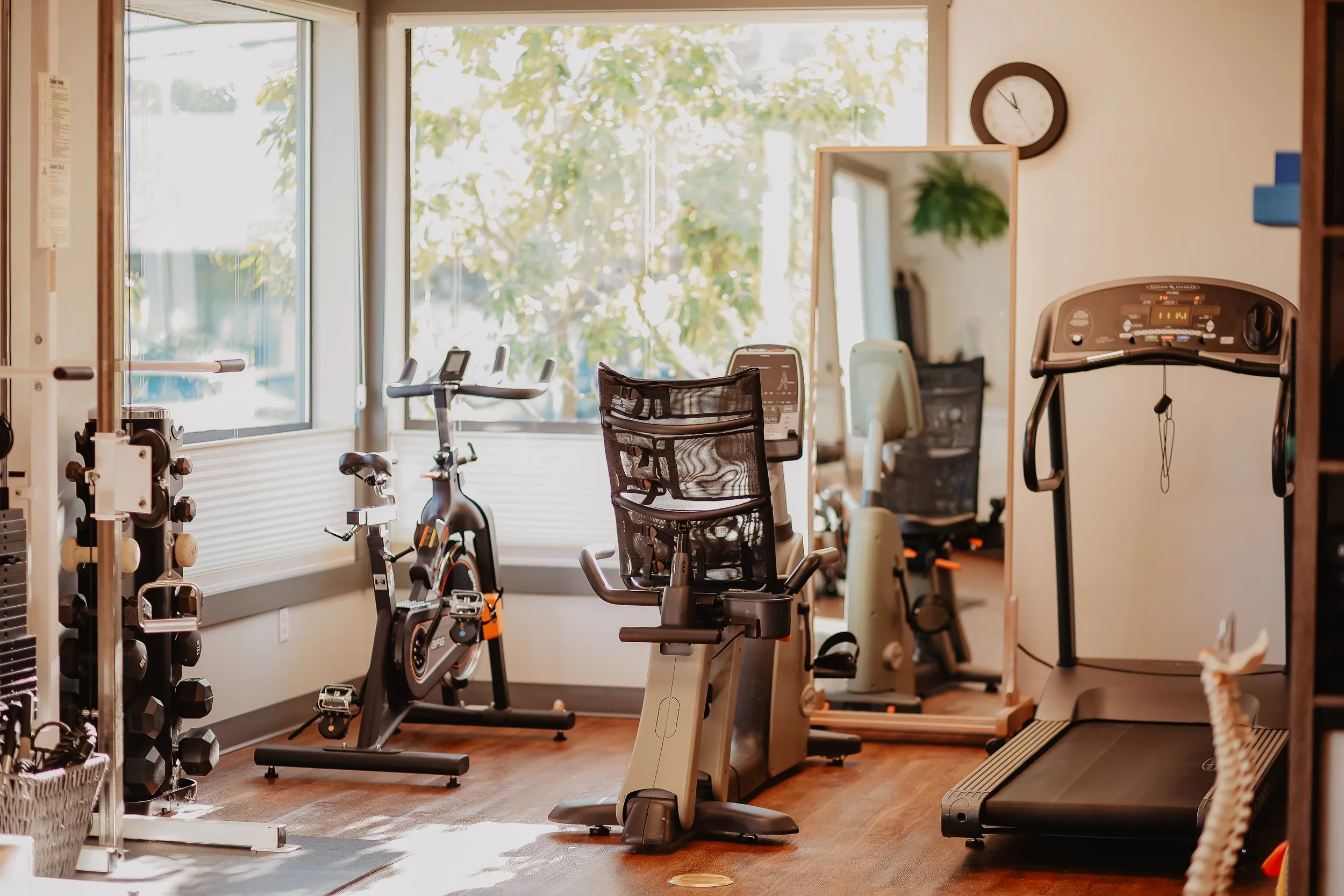 Cable machine and weights for strength training, spin bike, recline bike, and treadmill for cardio in rehab gym - Best Physiotherapist Campbell River