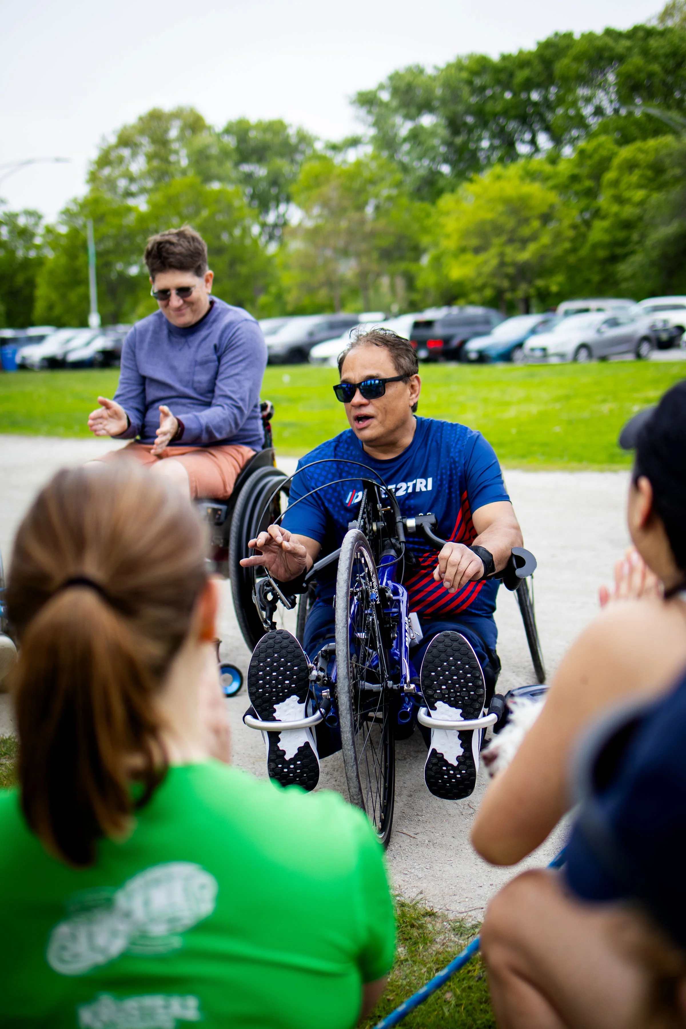 A Dare2tri Storytelling 5K participant in an adaptive bike tells a story at a stop