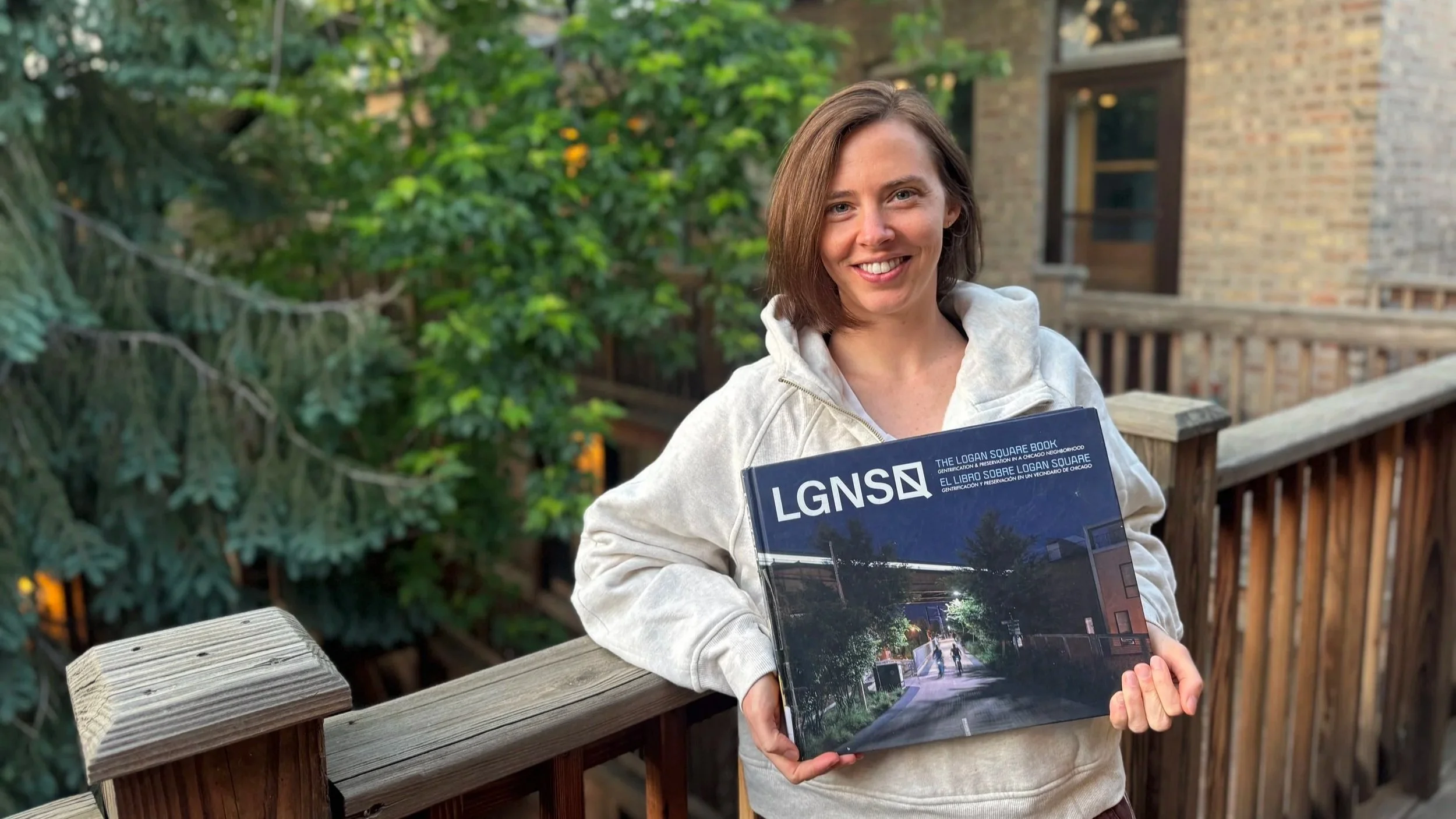 Grace McGann with LGNSQ book about Logan Square, Chicago