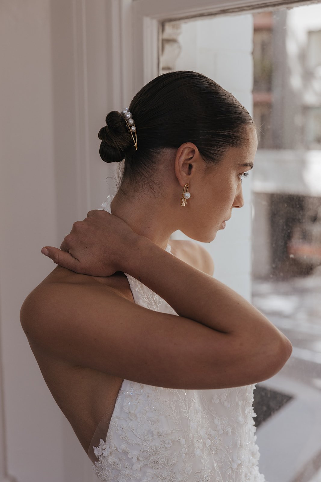 Modern bridal earrings and Jewelry for Minimal Classic Brides. Model wearing Gaia Earrings with rhinestone and pearl details. Jade Oi Studio.