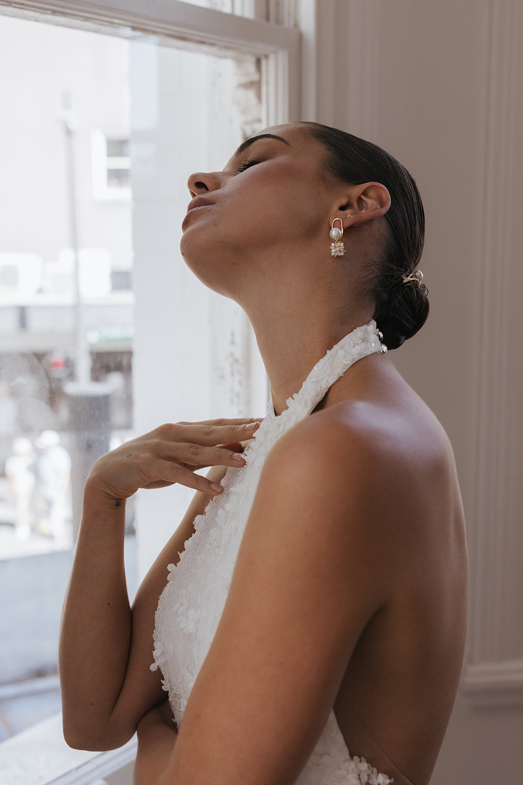 Modern bridal earrings and Jewelry for Minimal Classic Brides. Model wearing Gaia Earrings with rhinestone and pearl details. Jade Oi Studio.