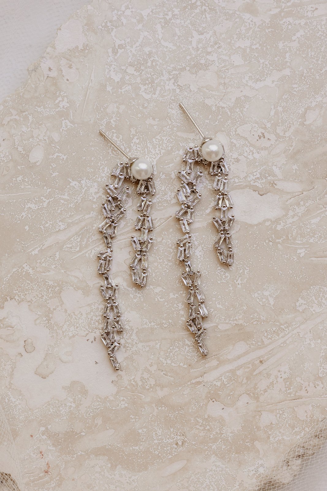 Jade Oi Studio Modern Bridal Jewelry, White Gold Rhinestone Pearl Drop Horseshoe Maisily Wedding Earrings for Brides. Bridal Editorial for Wedding Trends.