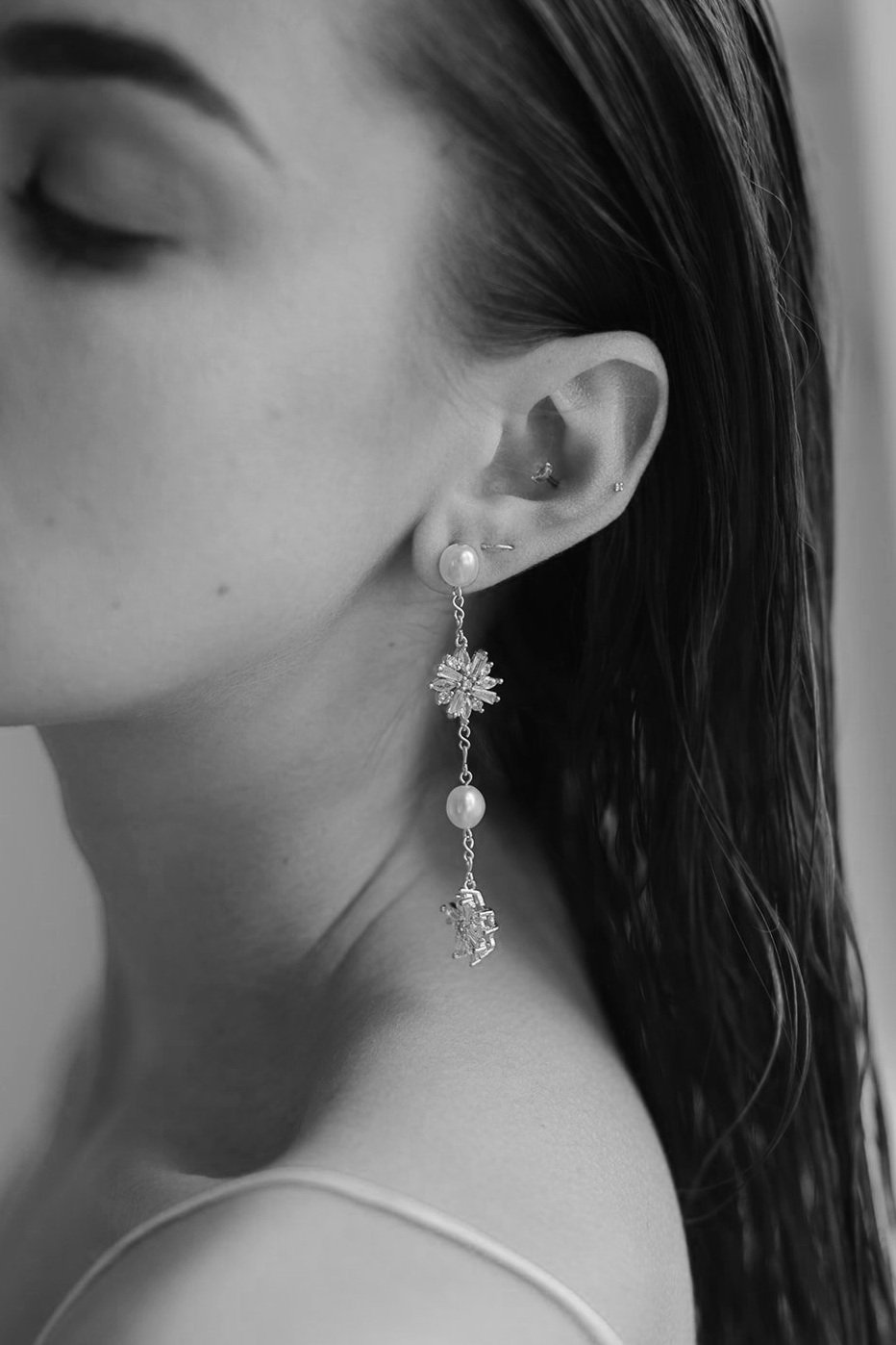 Modern bridal earrings and Jewelry for Minimal Classic Brides. Model wearing Sofia Earrings with rhinestone stars and baroque freshwater pearls long statement wedding earrings. (Copy)
