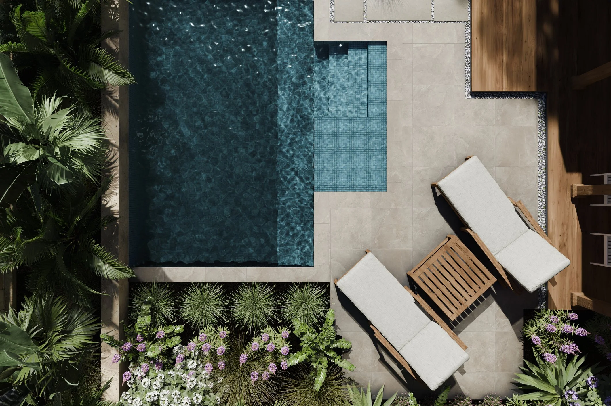 An outdoor pool area with lush green plants, beige tile flooring, and two wooden lounge chairs with white cushions.