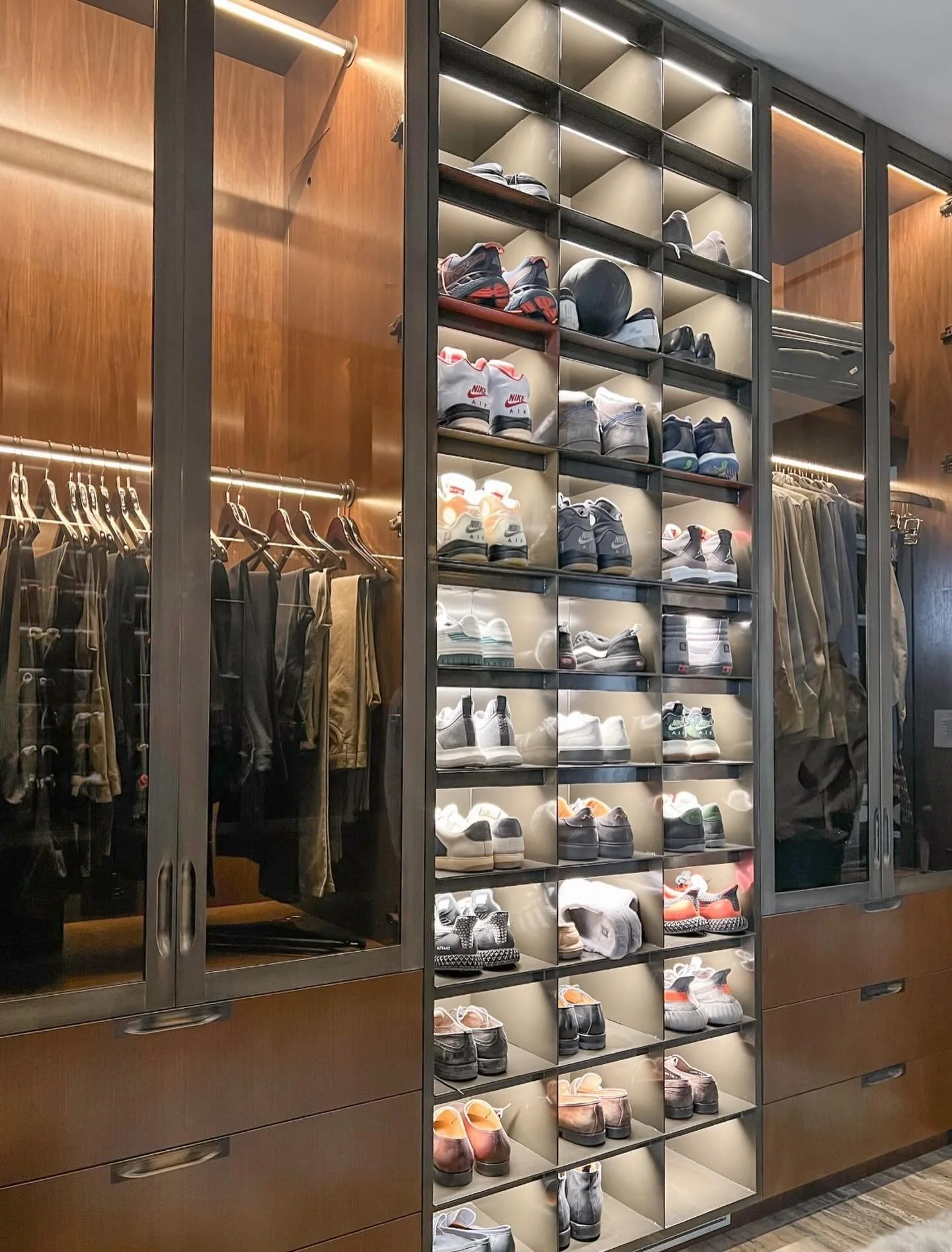 Solid milled, patinaed brass and glass inlaid closet doors finish out this beautiful walk in closet!