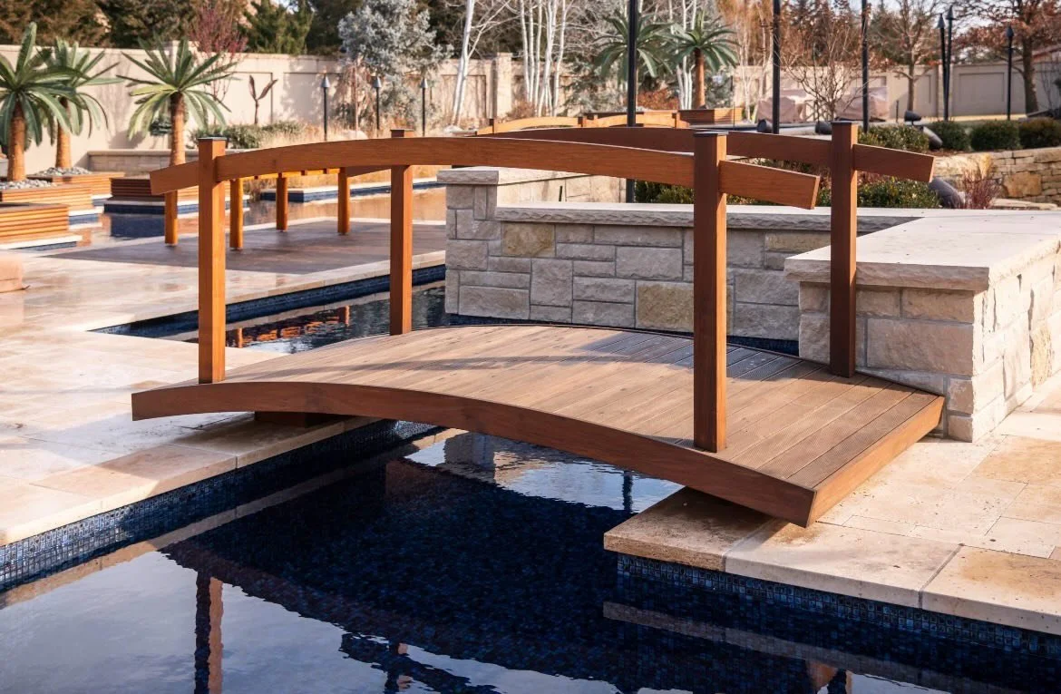 Hidden steel framing  makes this beautiful ipe bridge appear to float over the pool! Hidden lighting transforms it at night.