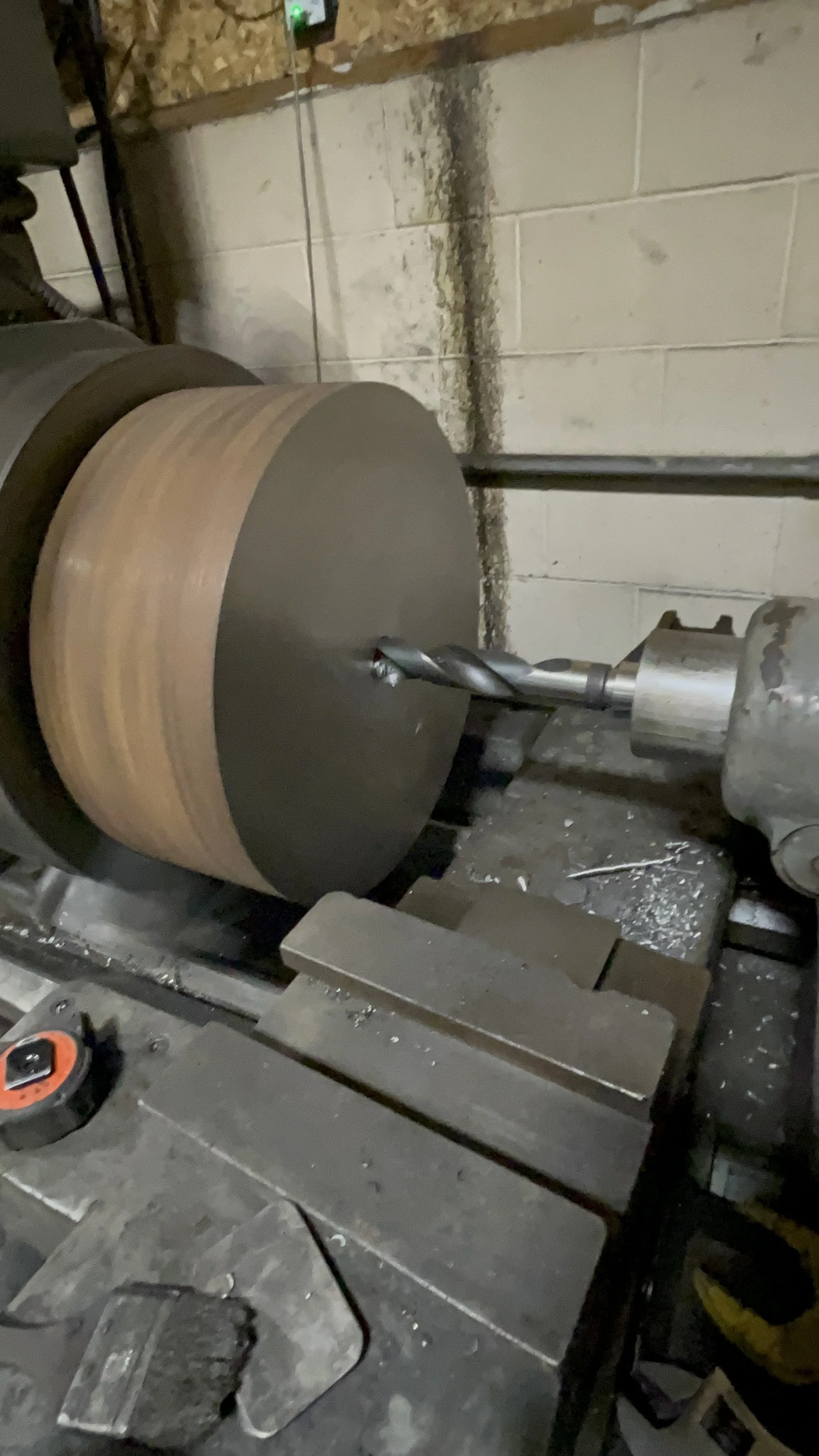 Large lathe turning a 18" trommel wheel.