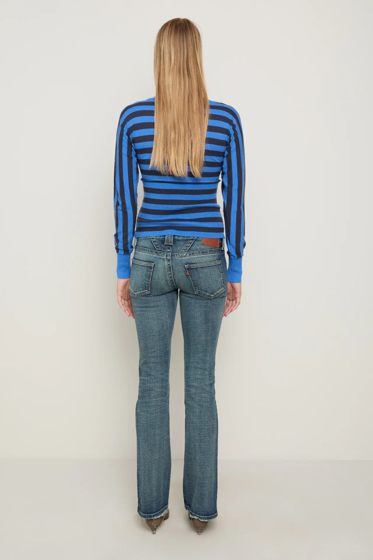 ODESSASWEATER_BLUESTRIPES_IMAGE-ECOM_MEDIA-STILL_CROP-FULLBODY_ANGLE-BACK.webp
