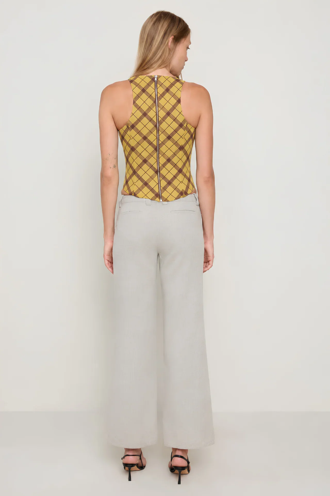 ANNIKACORSET_MUSTARD_PLAID_IMAGE-ECOM_MEDIA-STILL_CROP-FULLBODY_ANGLE-BACK.webp