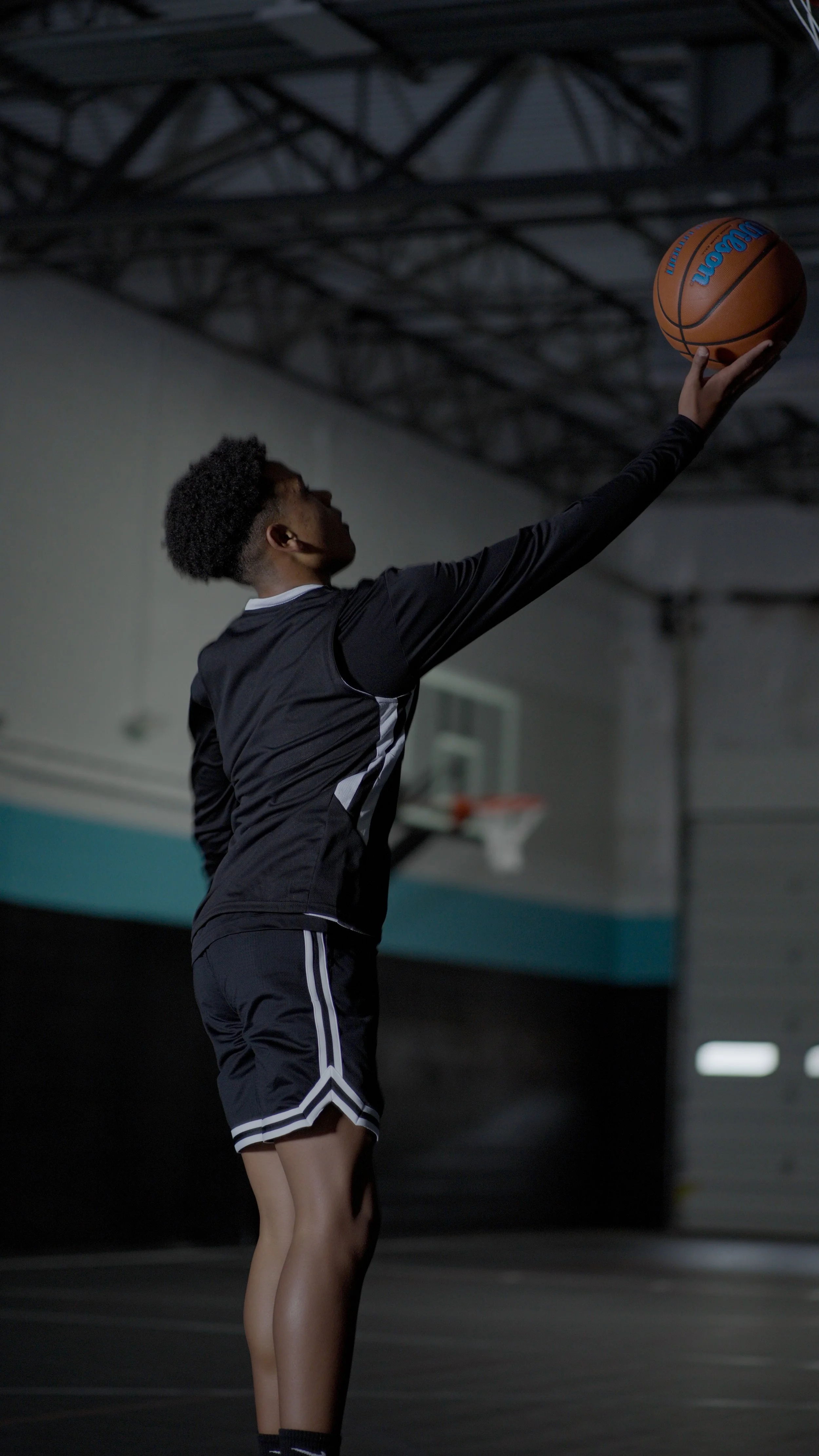 young man making a layup basketball shot showcasing Next Up Nova Basketball Training