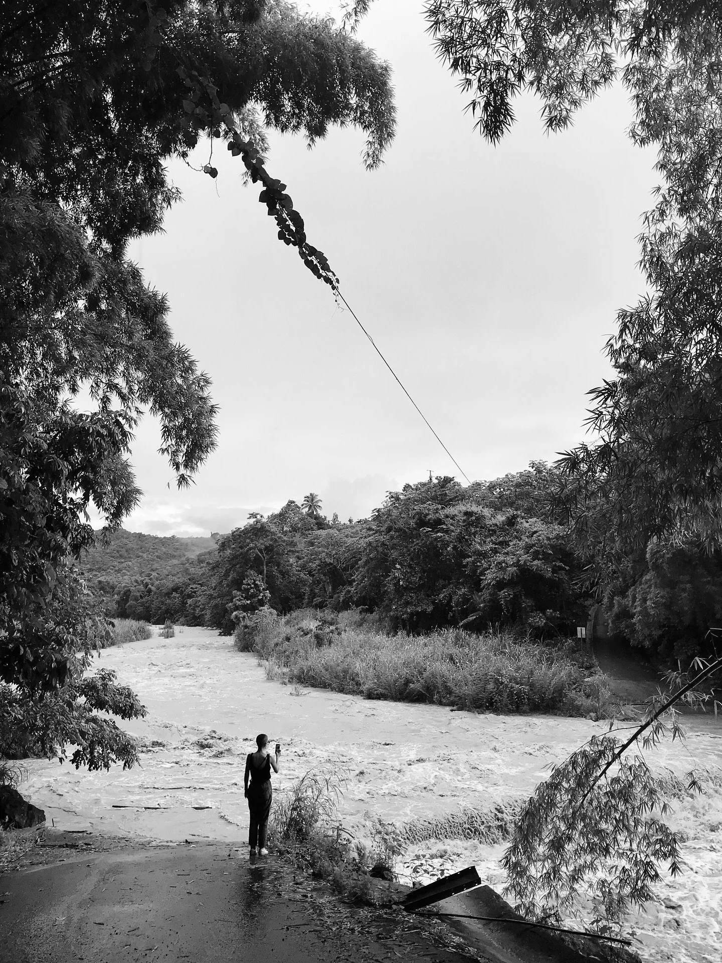 This bridge into the neighborhood saves us half an hour, when it&rsquo;s not underwater. Steven made this picture of me on our way home from town, after an afternoon of very average rain.