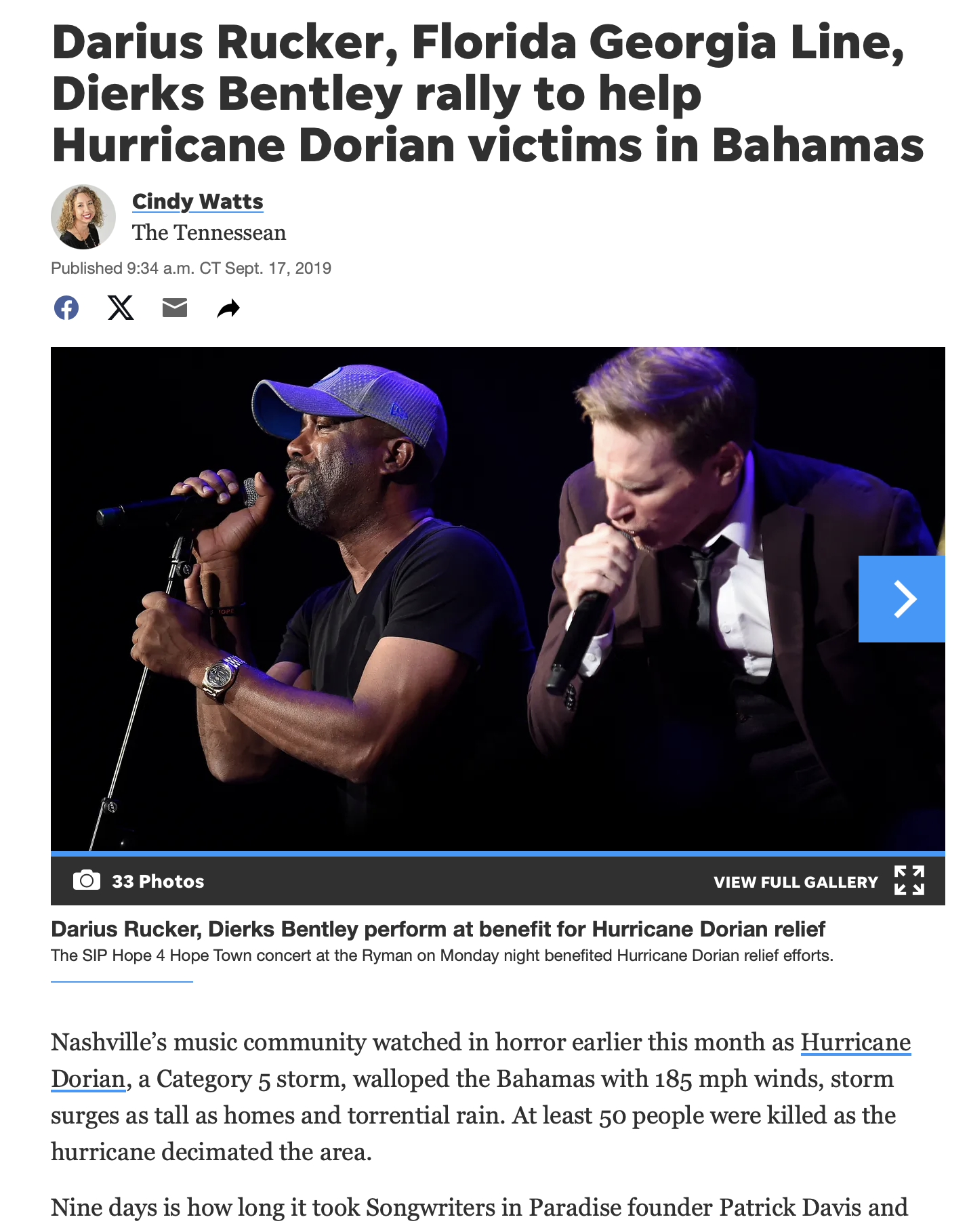 Darius Rucker and Dierks Bentley performing on stage at a benefit concert for hurricane Dorian relief, with both holding microphones.
