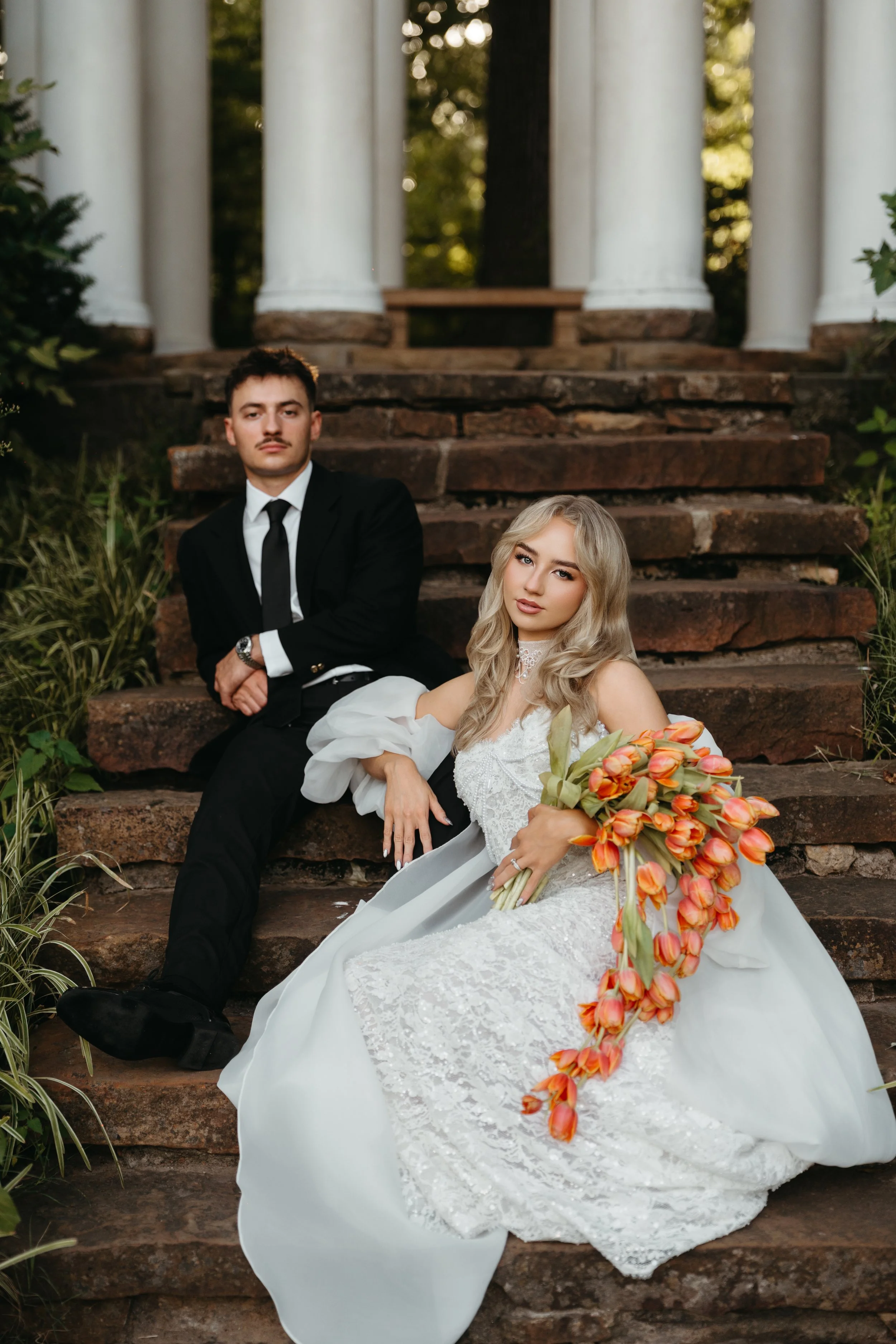Editorial wedding portrait with a cascading orange tulip bouquet by Dallas Blooms Events.