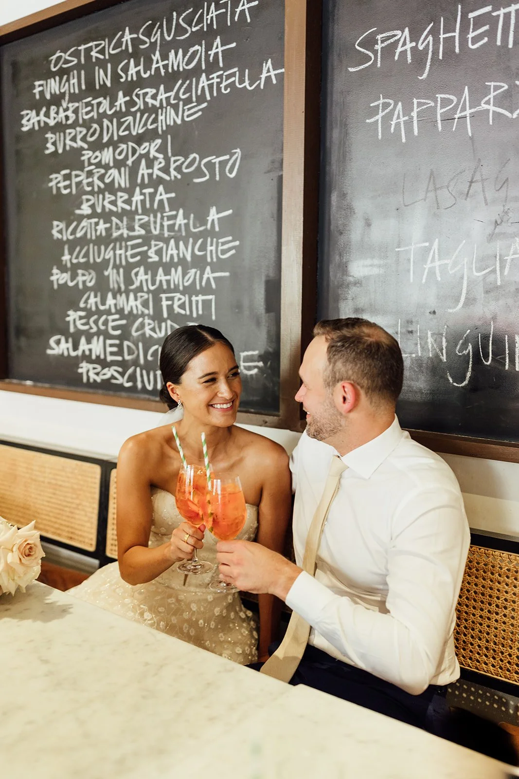 Bride and Groom having an aperol spritz at a restaurant