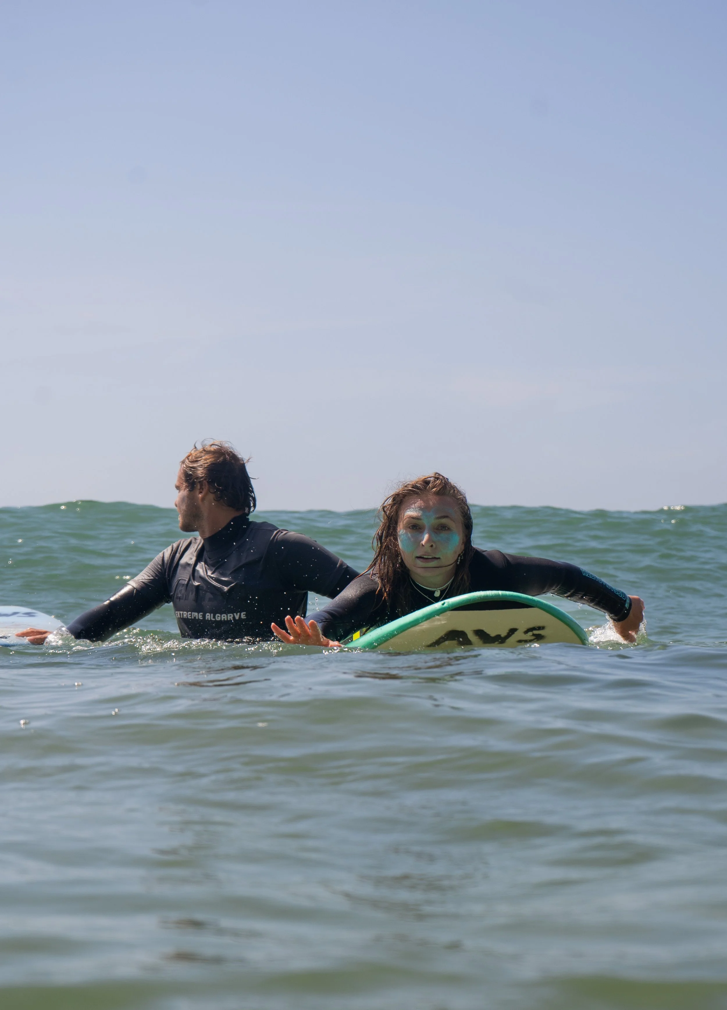 Instructor and student surfing in the ocean 