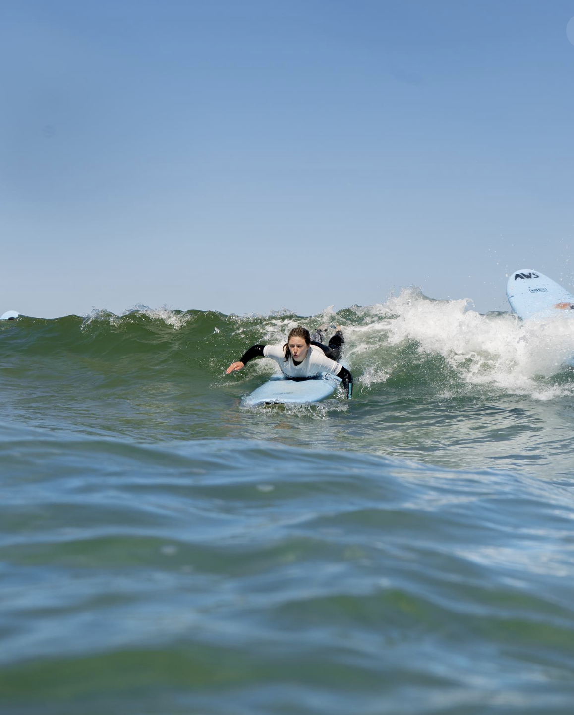 Surfer in the water surfing in Portugal 