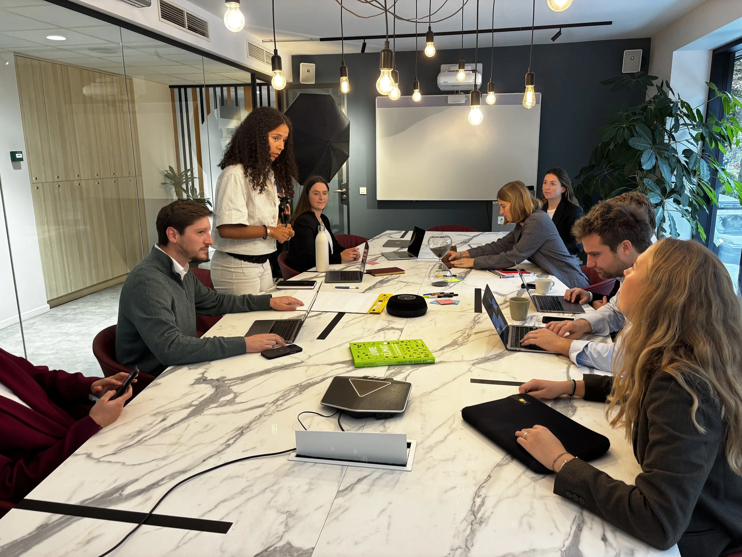 picture of colleagues doing a workshop on a big marble table