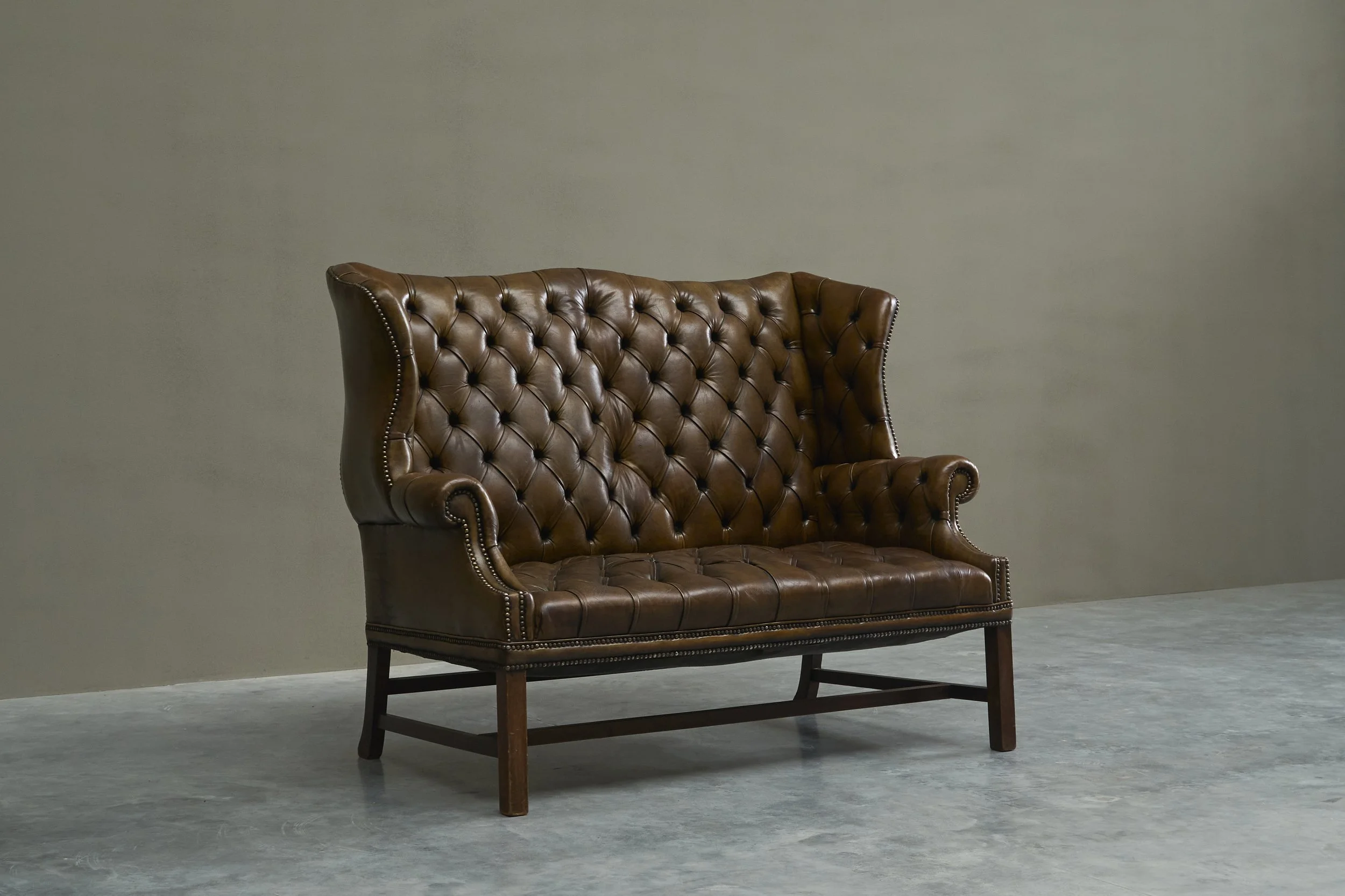 Highly Original Tufted English Wingback Settee in Patinated Leather England Early 20th Century