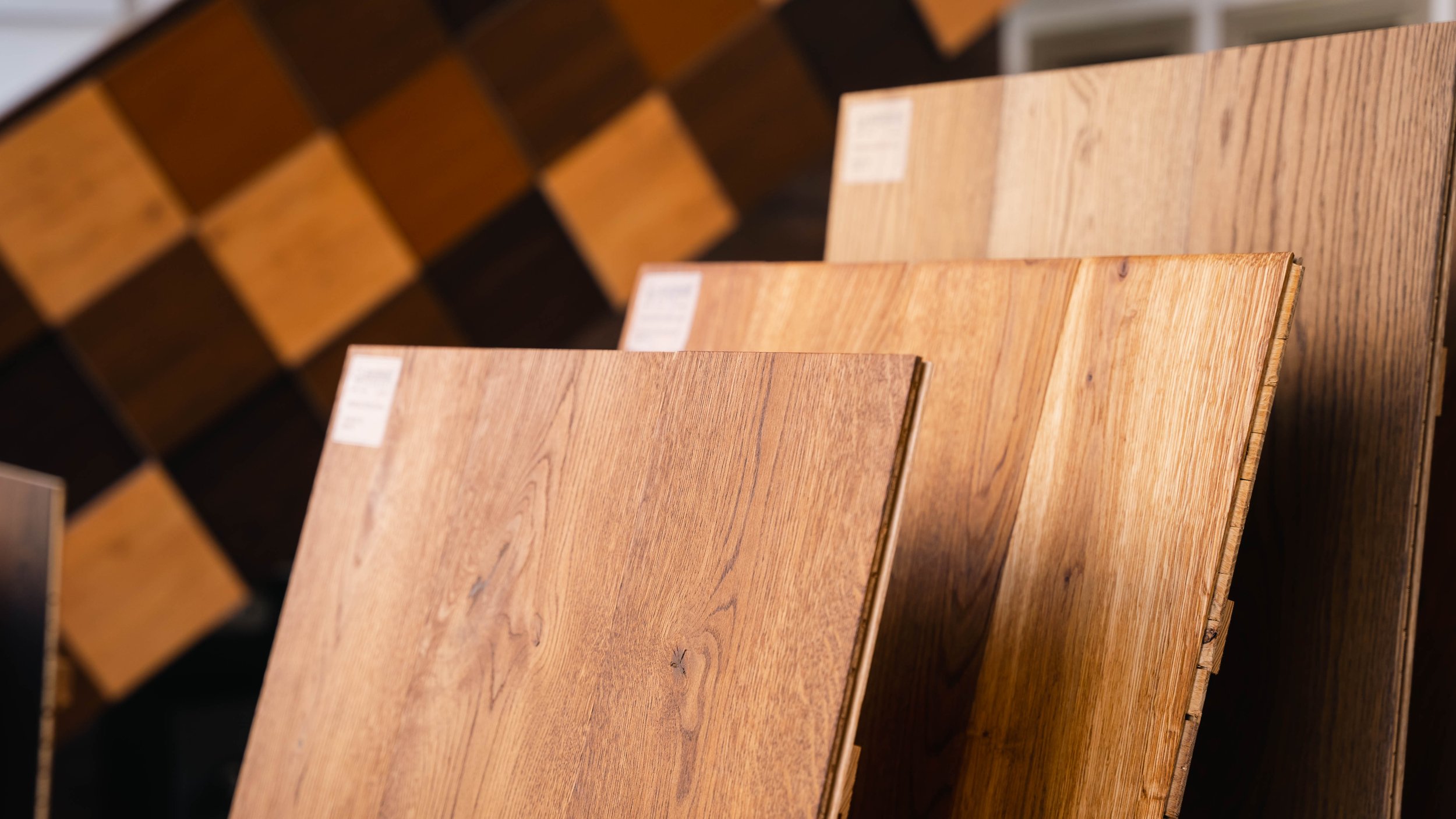 Multiple wooden flooring samples in different shades arranged in a display.