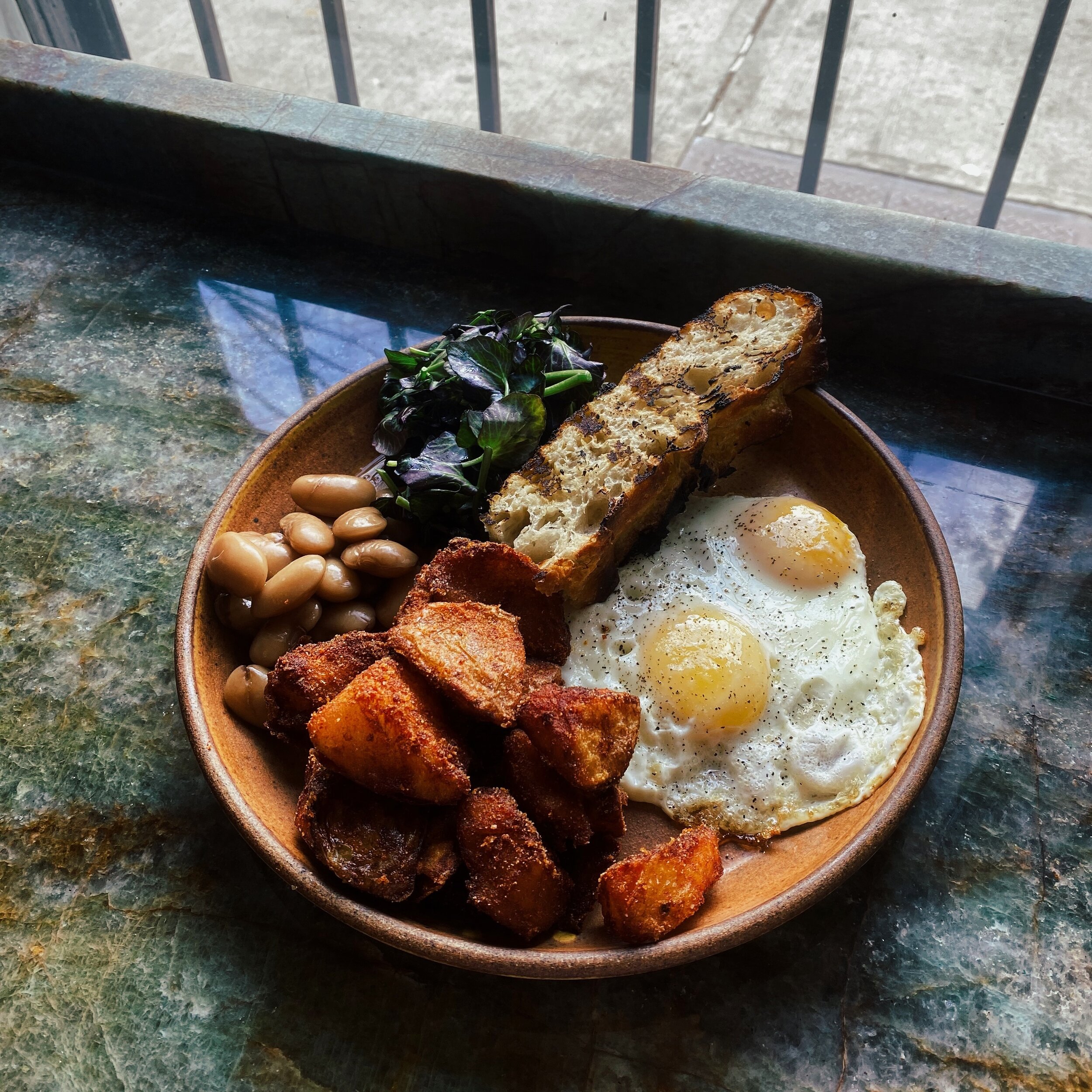 Back at it again for brunch today, 11-4pm!

Our breakfast plate comes with two eggs any style, our house made focaccia, brothy beans, watercrest, and our crispy spiced potatoes.