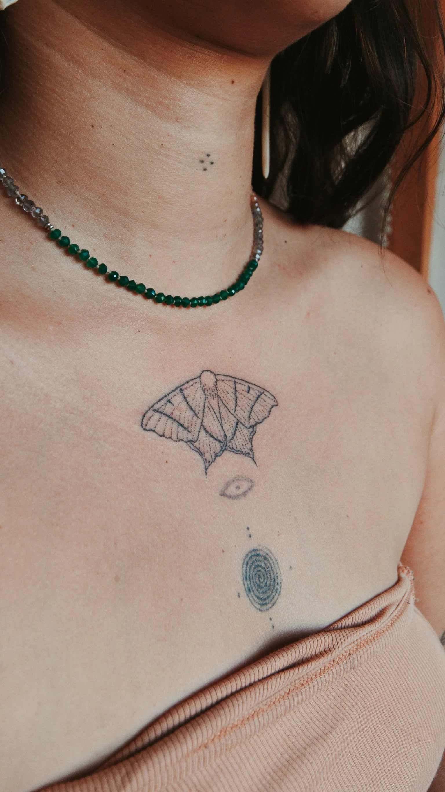 Handpoked tattoo of a moth. Created in ceremony with intention