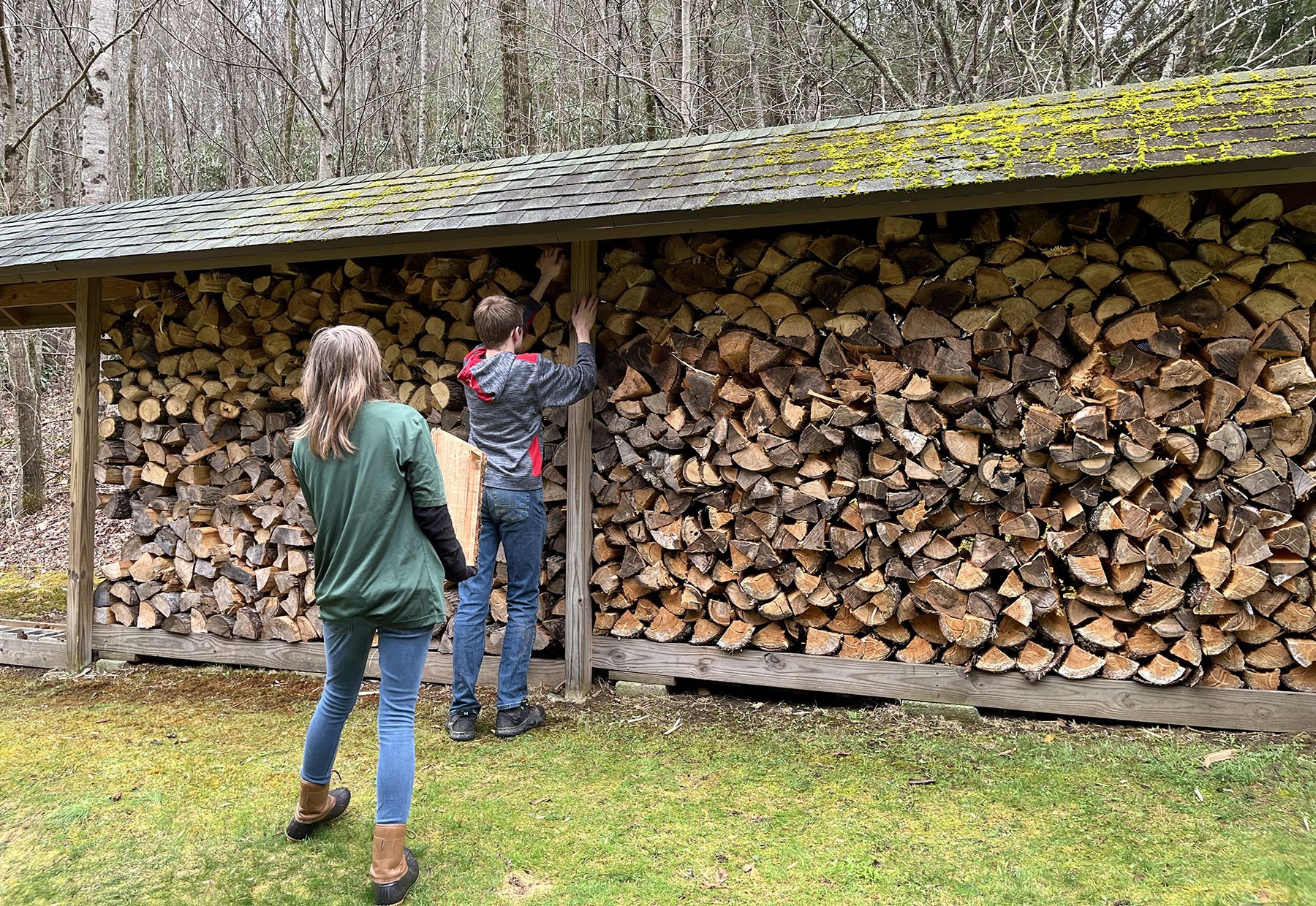 Lumberjack Stacking Wood at Whisper Mountain Camp IMG_0708.jpg