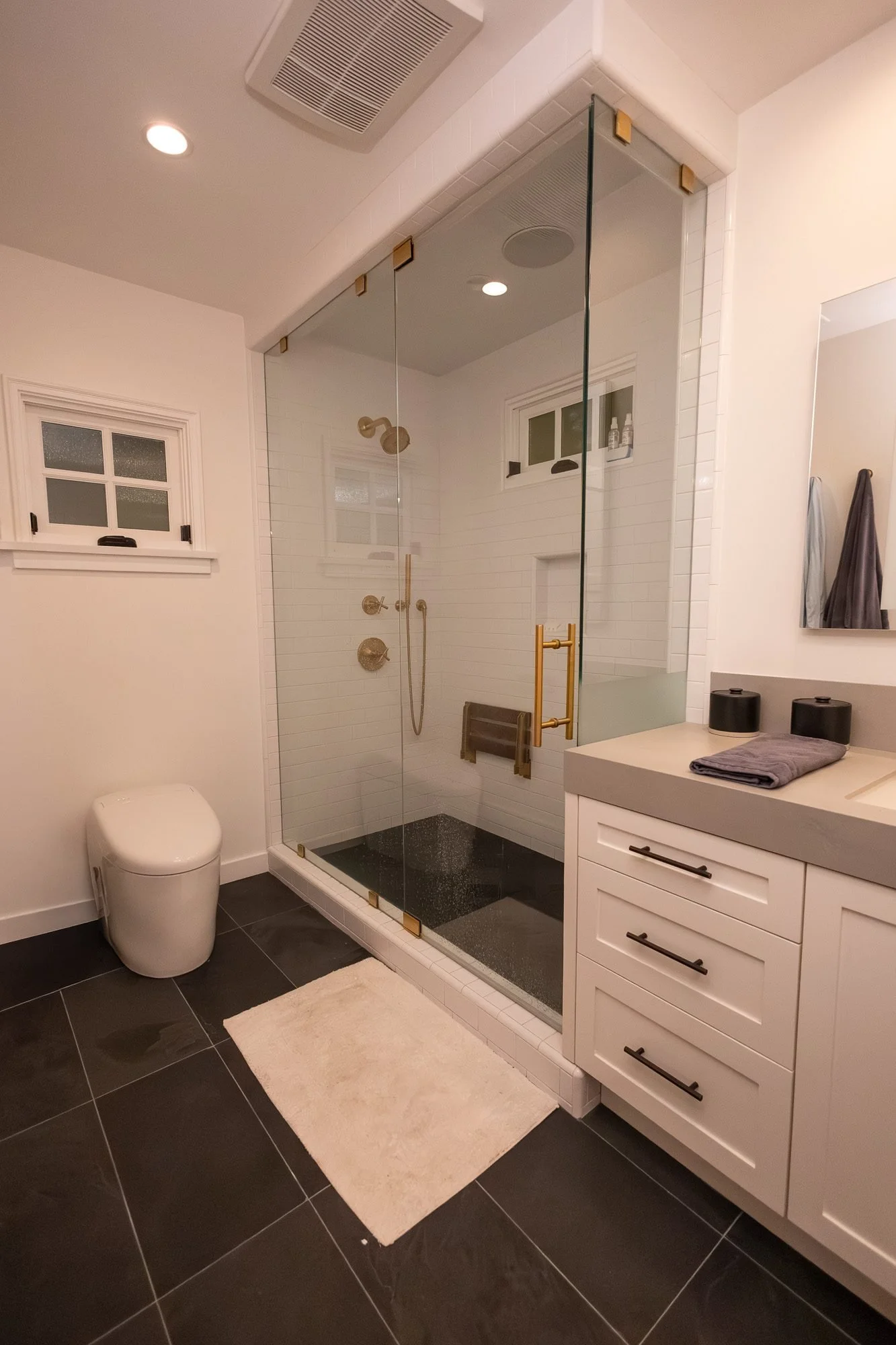 Bathroom with glass-enclosed shower and gold fixtures