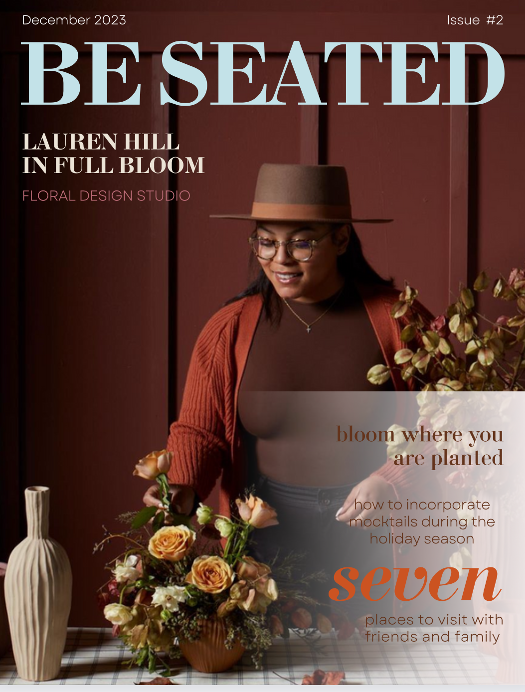 Cover of Be Seated magazine featuring Lauren Hill arranging a floral bouquet against a brown wooden background, with the title "Be Seated" in large blue letters and articles about floral design and holiday mocktails.