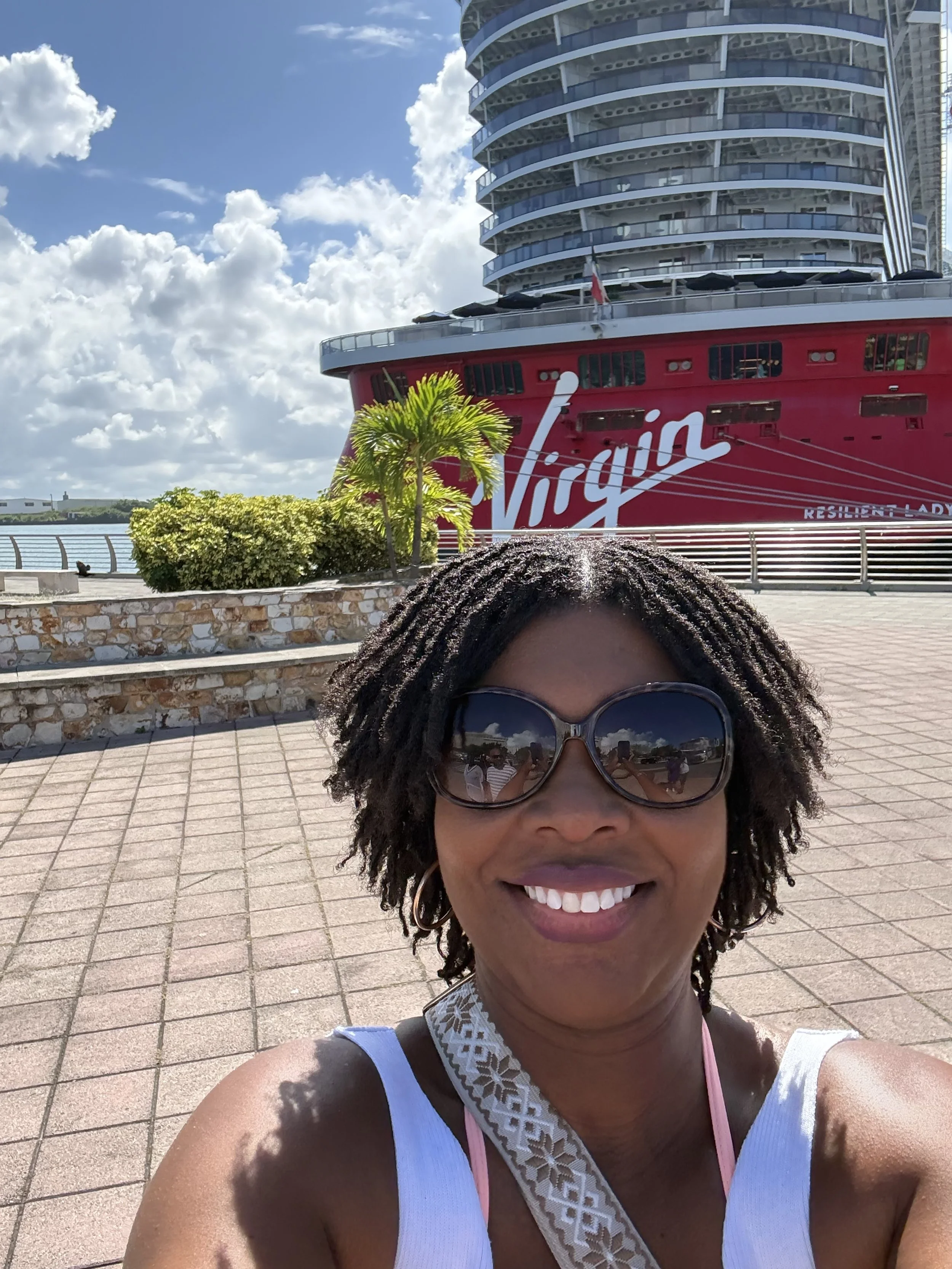 African American woman in front of cruise ship