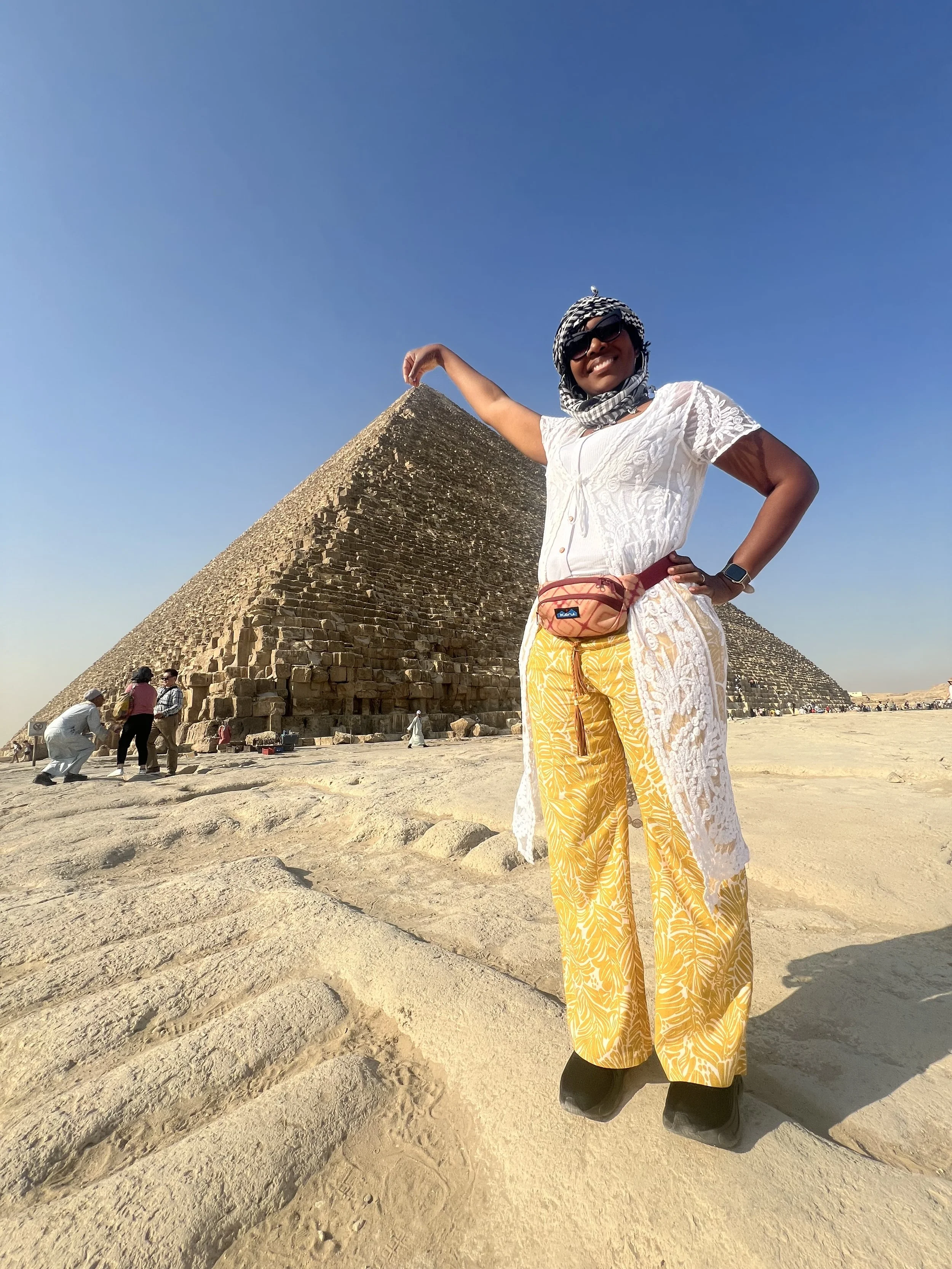 Black Woman standing by pyramid in Egypt