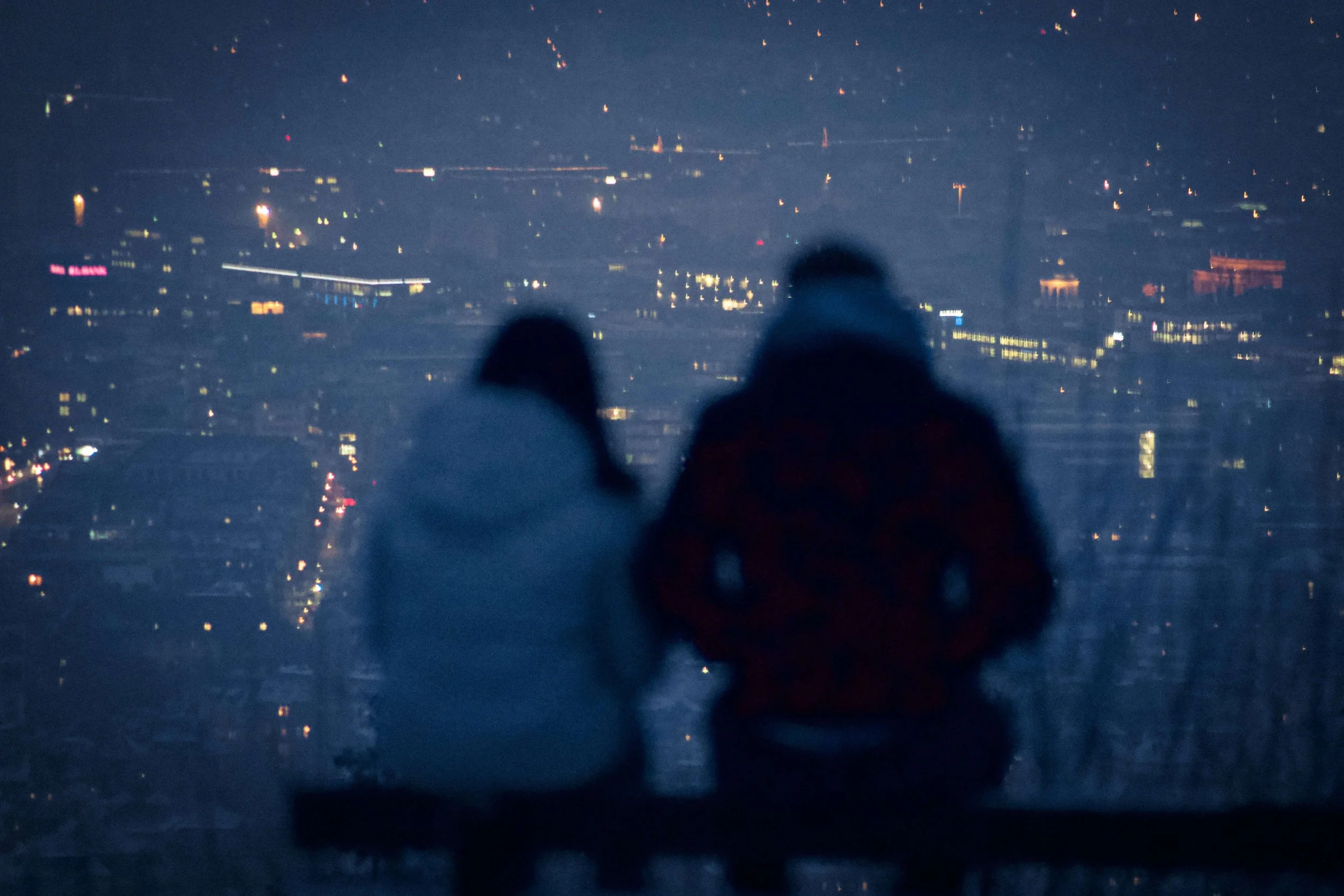 A husband and wife sit side by side overlooking a city, yet feel emotionally distant. Christian counseling in Columbus, OH helps women discern if their relationship is abusive and find clarity through faith.