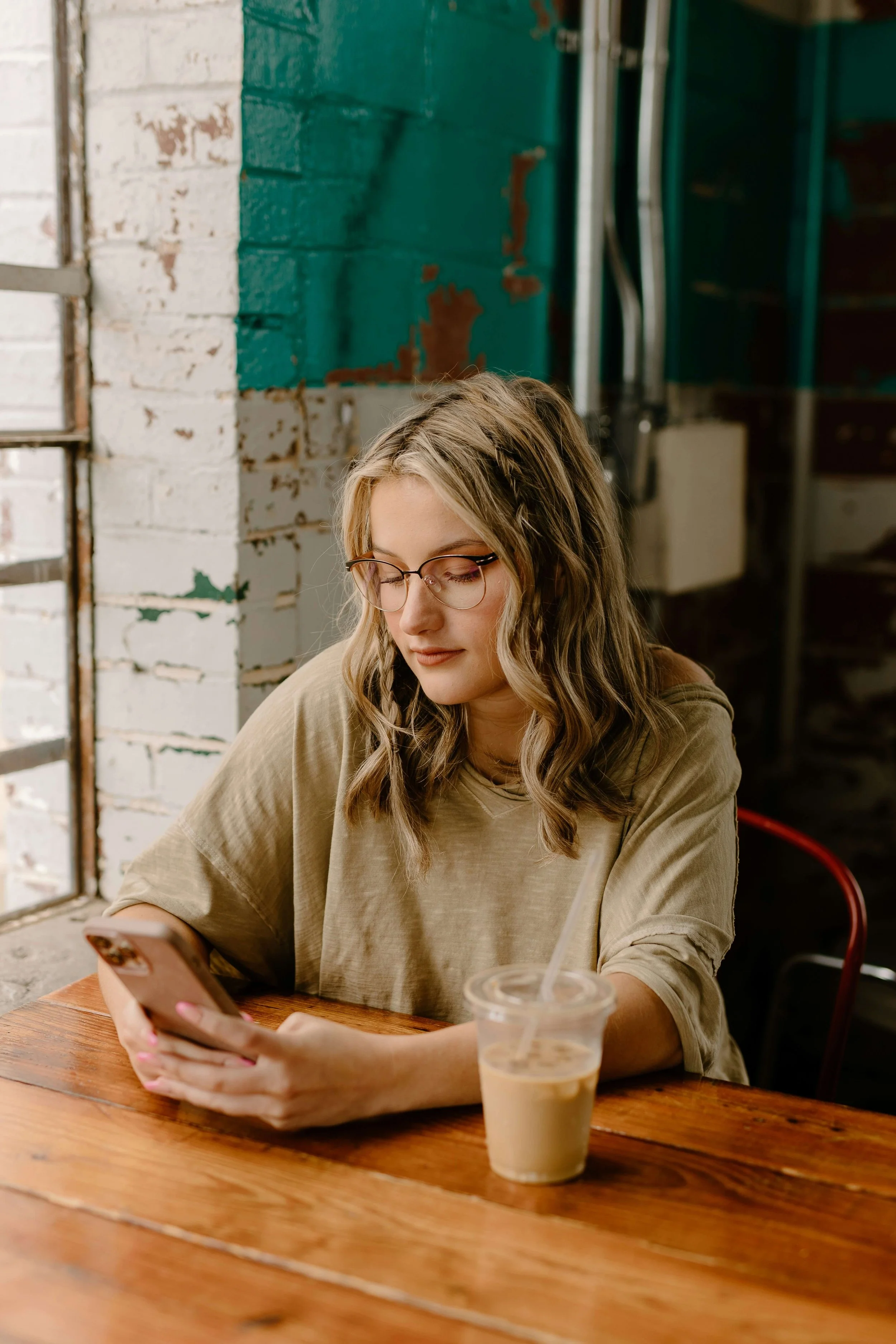 A woman attends an online counseling session from home using her phone. Online Christian counseling in Columbus, OH, helps women heal people pleasing, anxiety, and trauma through faith-based therapy and emotional support.