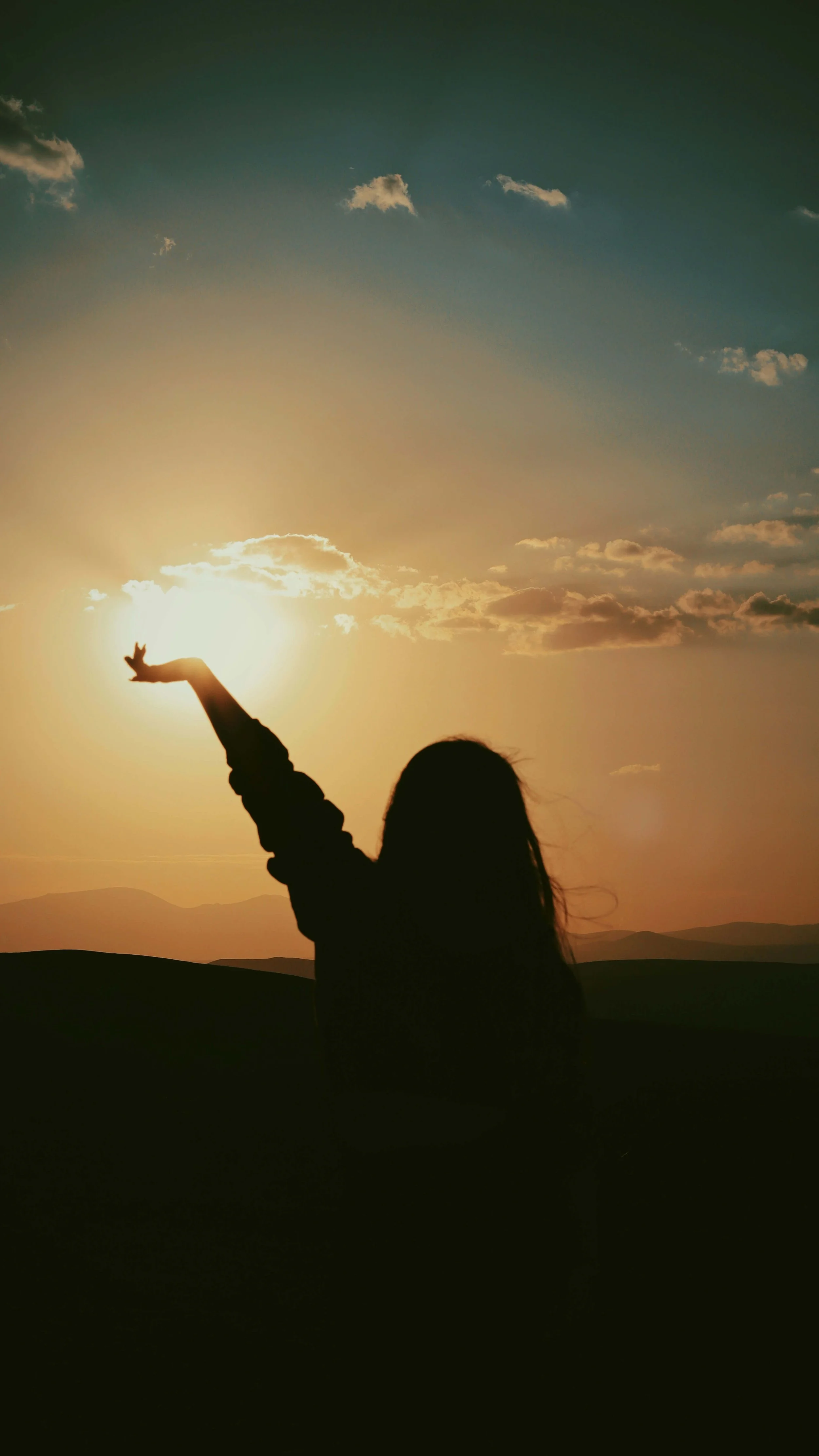A woman raises her hands in worship. Faith based counseling helps integrate emotional healing with devotion and prayer. Online Christian counseling in Columbus, OH supports women seeking restoration of mind, body, and spirit.
