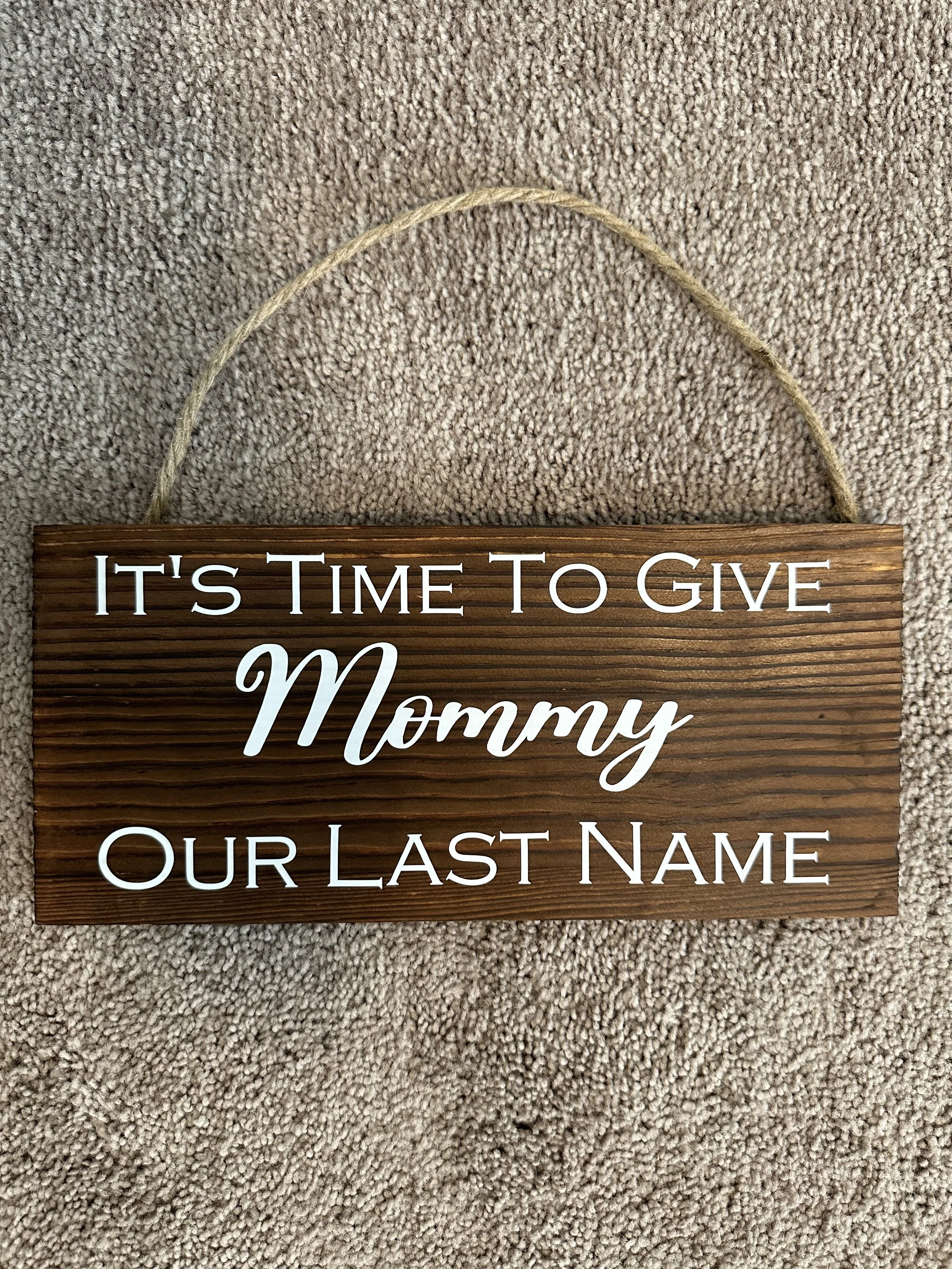 "It's Time to Give Mommy our Last Name" sign