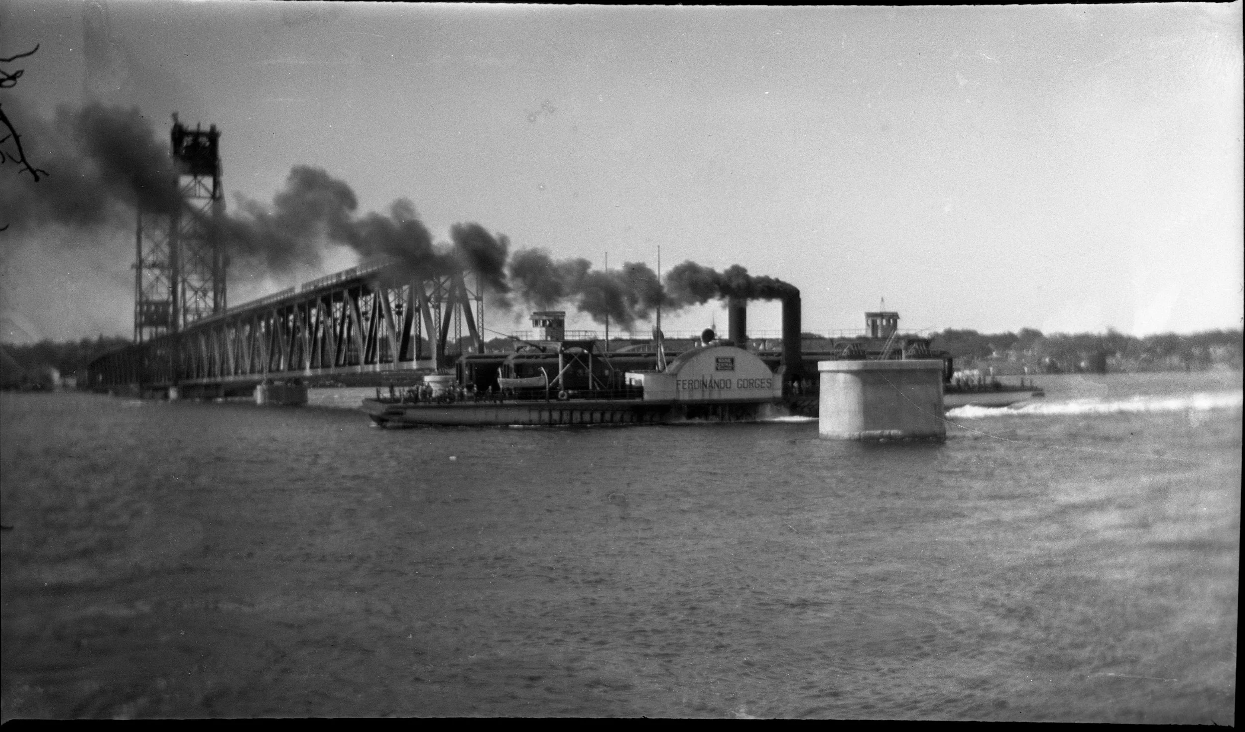 The Carlton Bridge, construction in progress, with the Ferdinando Gorges sidewheel ferry in the foreground. BHS2019.9.1