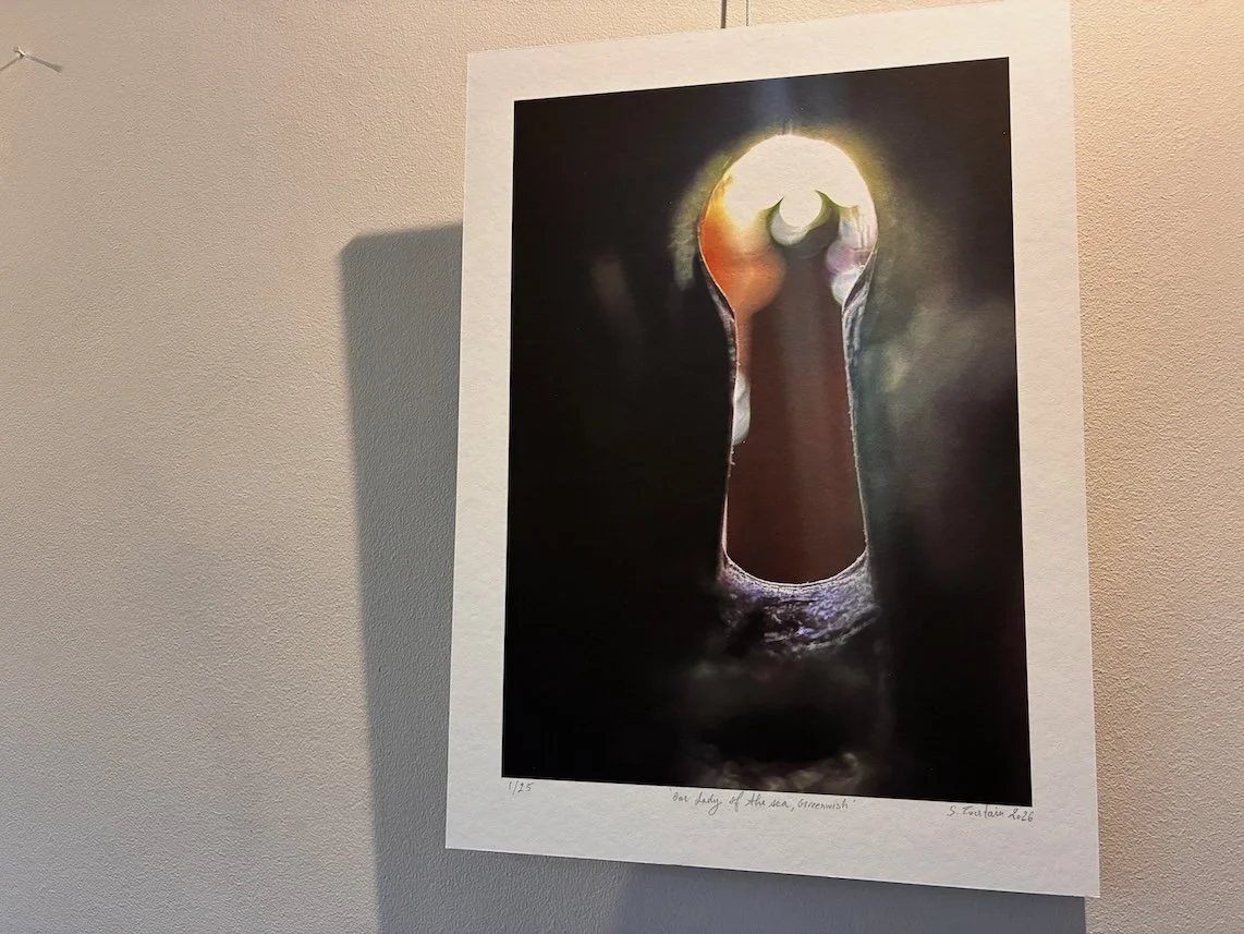 A photographic artwork showing the interior of a church seen through a keyhole, with light spilling through, emphasising a restricted and partial view.