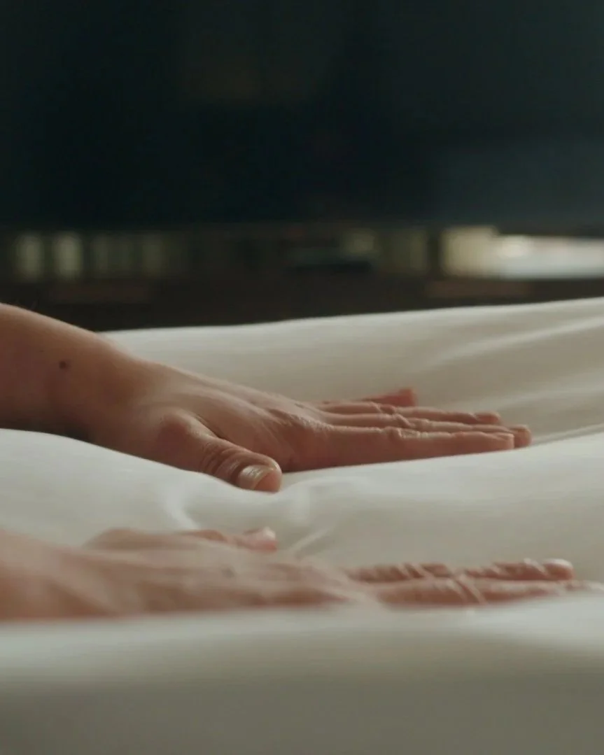 hands patting down and making a bed at the Westin Oaks Hotel in Houston, Tx