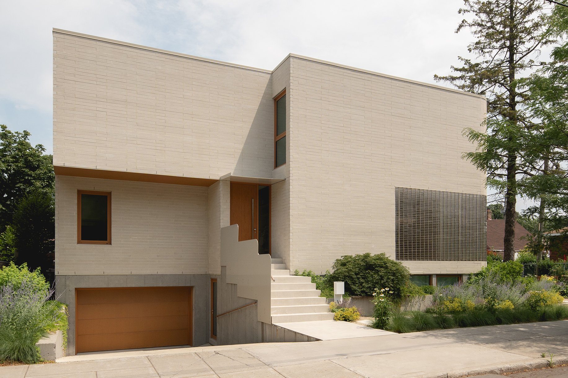 architecture-exterior-contemporary-minimalist-design-glass-facade-street-view-glass-bricks-entrance-lens-montreal.jpg
